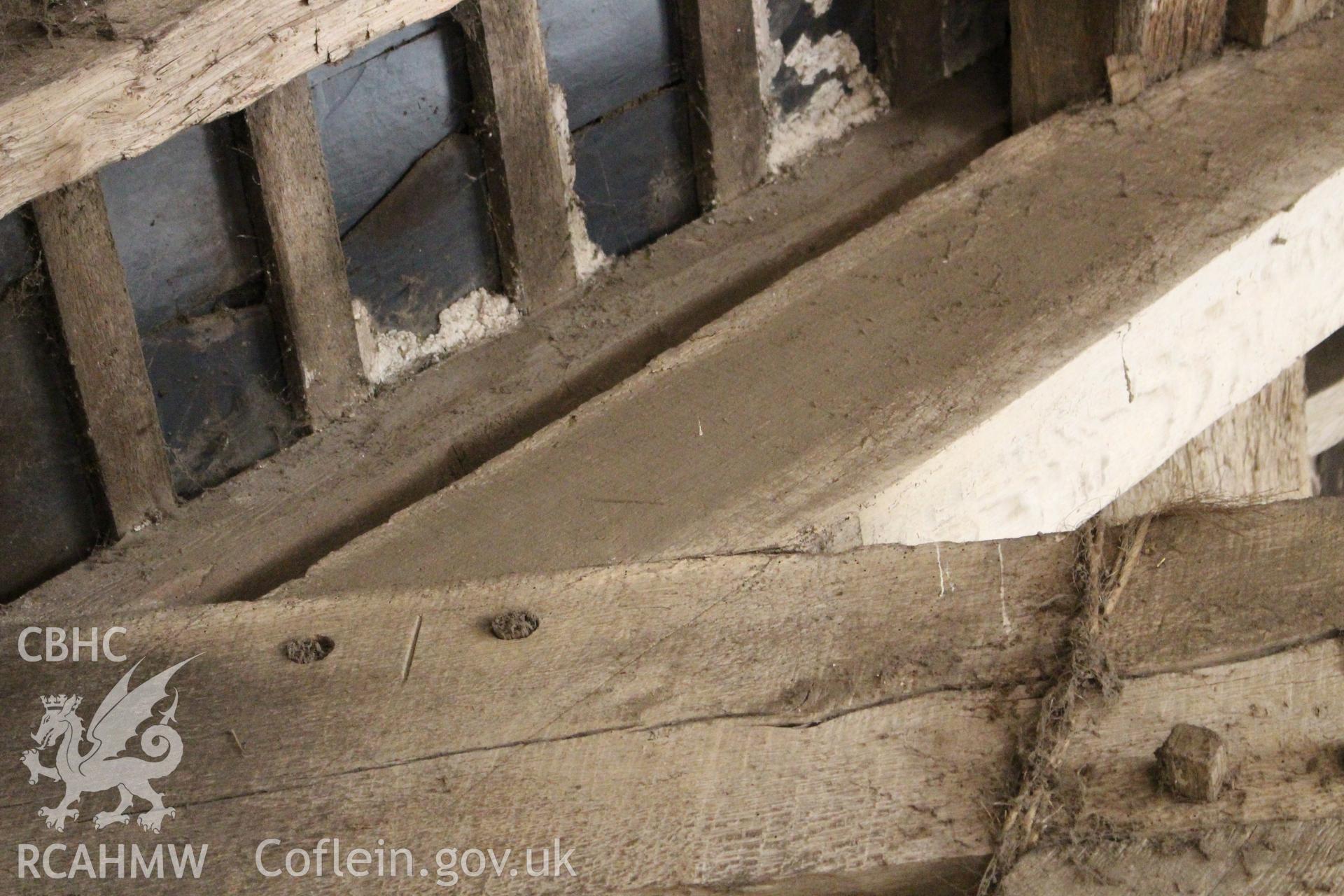 Interior; detail of pegging to principal rafter, showing carpenters marks.