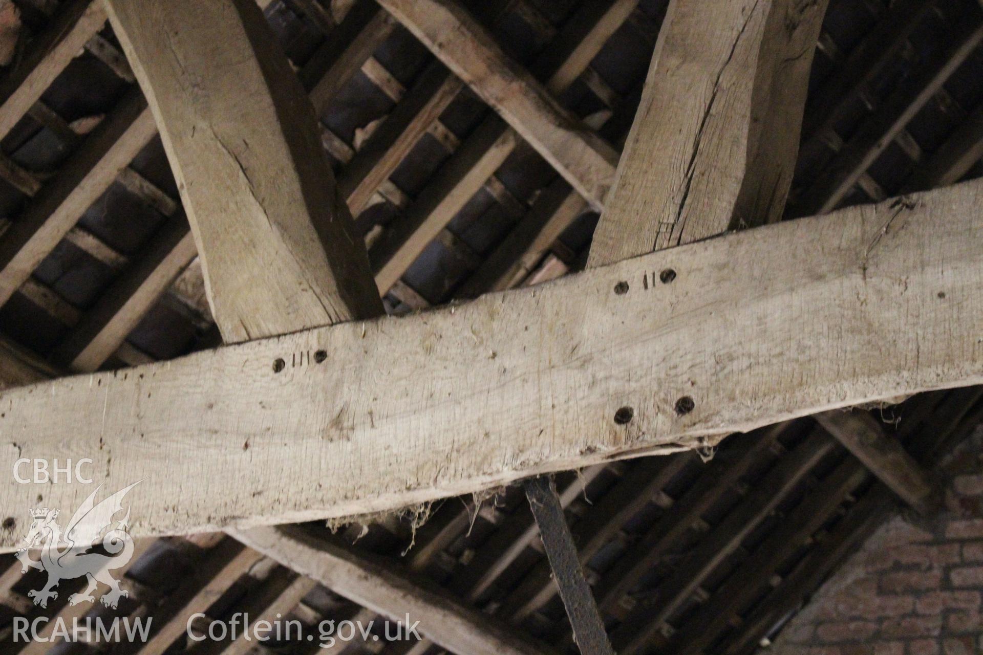 Interior; detail of pegging to raking struts and mortices for partition, also showing carpenters marks.