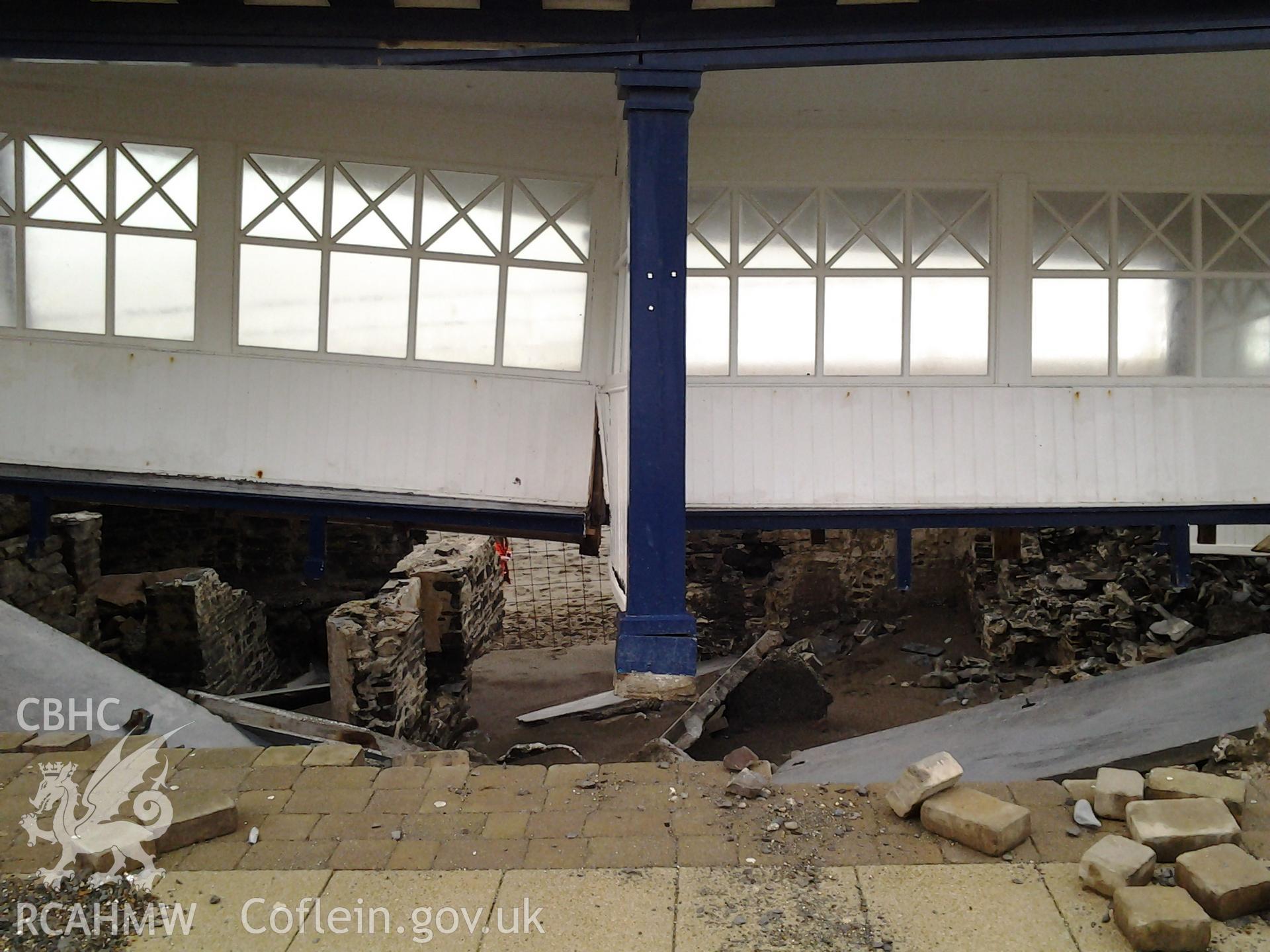 Northern end of collapsed seafront shelter undermined by a breech of the seawall