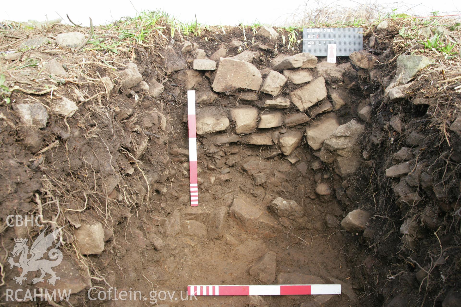 Skomer Island excavation of a burnt mound, Hut Group 8.  Post excavation view of the external face of the west roundhouse, context 109, overlying an earlier field lynchet, context 111 (Figure 7 in the excavation report).