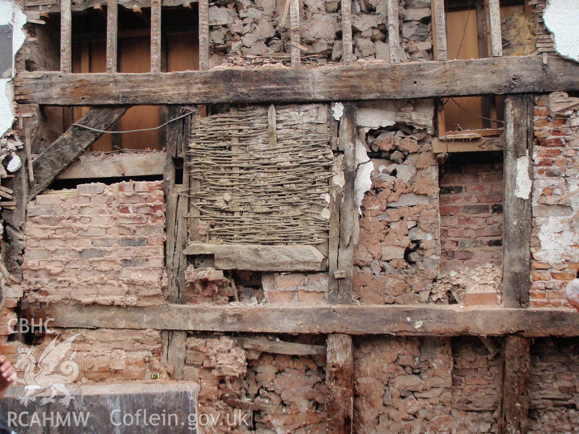 Detail showing blocked wattle later doorway under tie-beam with stud panels & cross-beam.