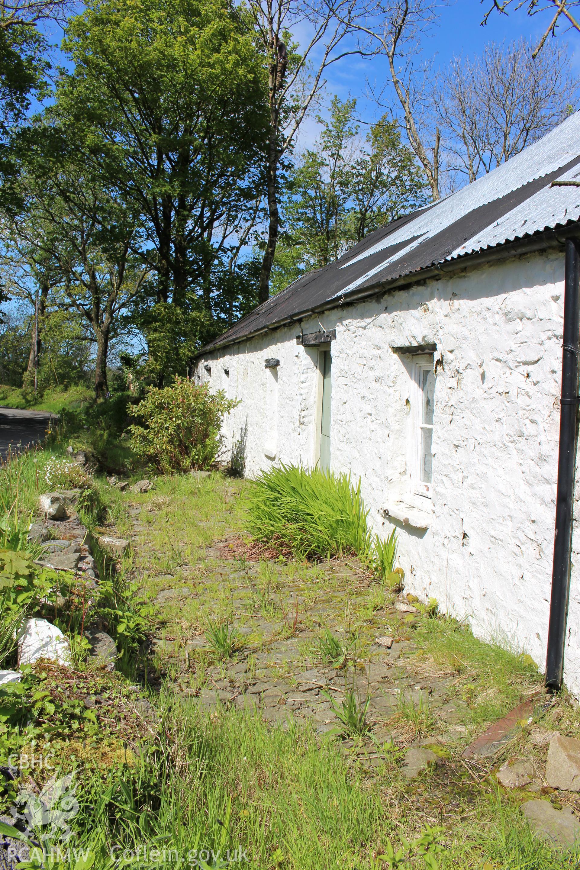 Exterior: west elevation, showing cobbling.