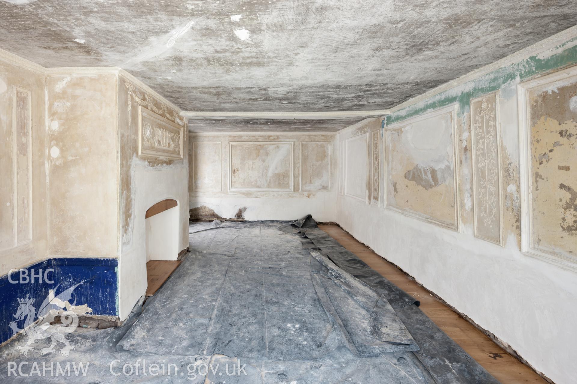 Interior of front plaster decorated room, looking southwest