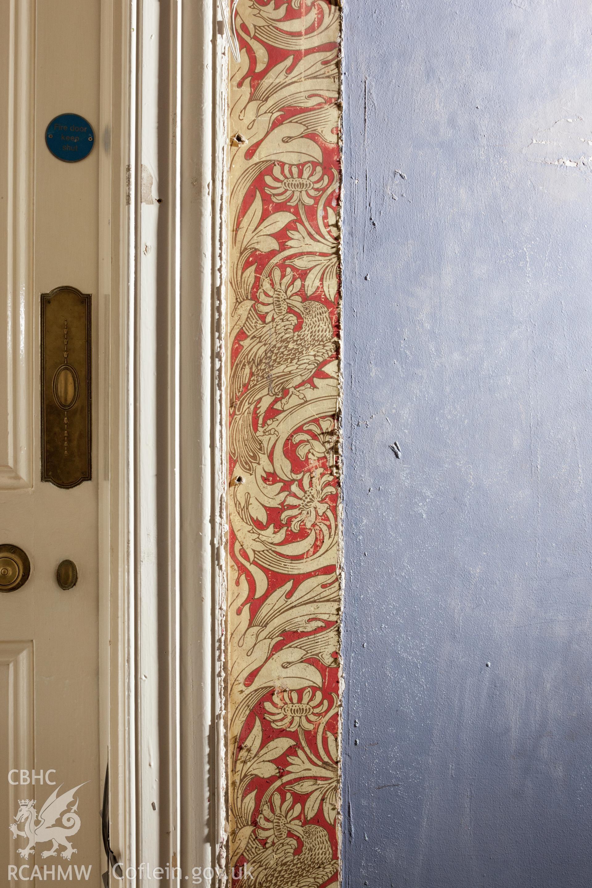 Early wallpaper uncovered by removal of door frame