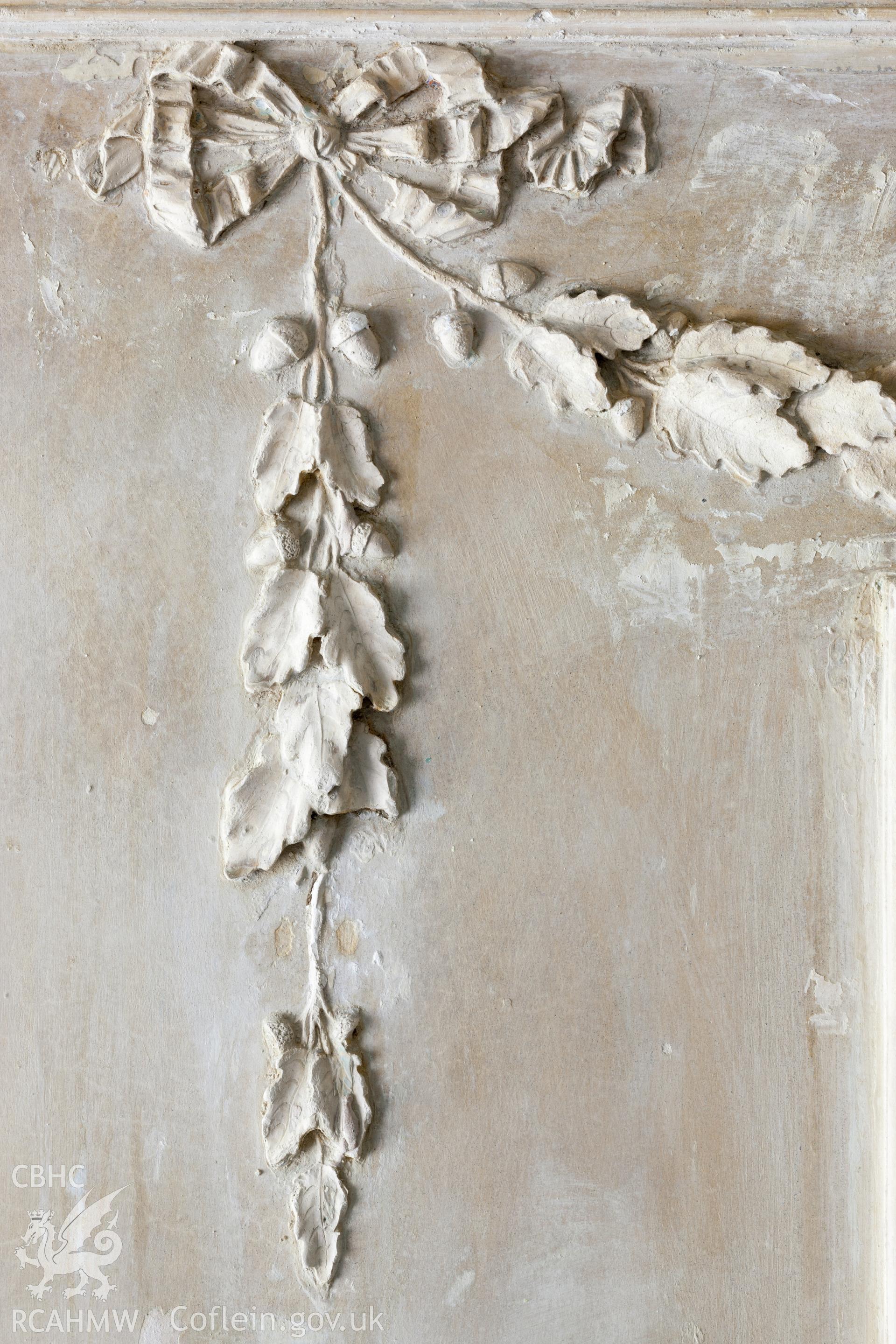 Interior of decorated plaster room, detail of plaster over fireplace