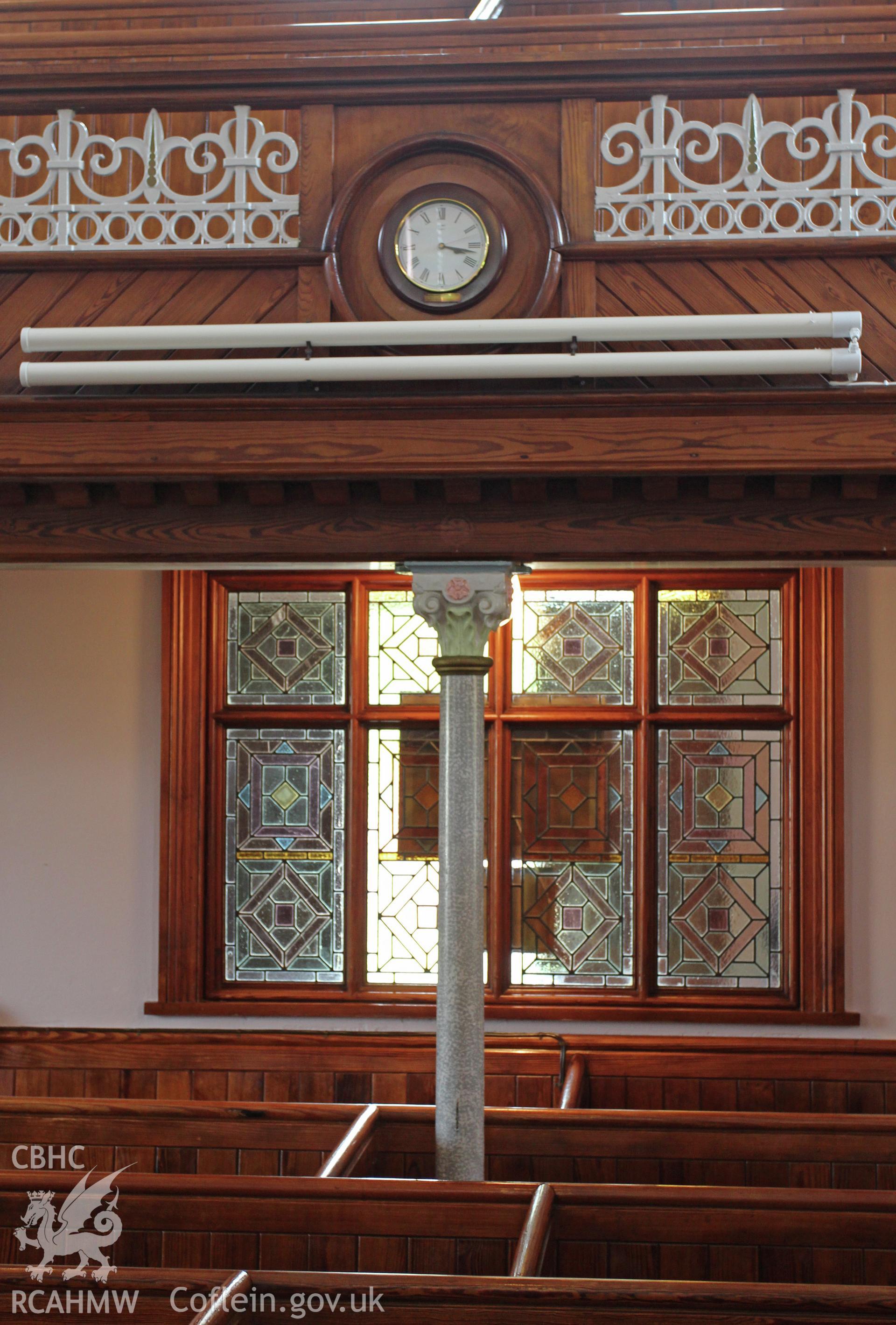 Detail of gallery front, column and clock