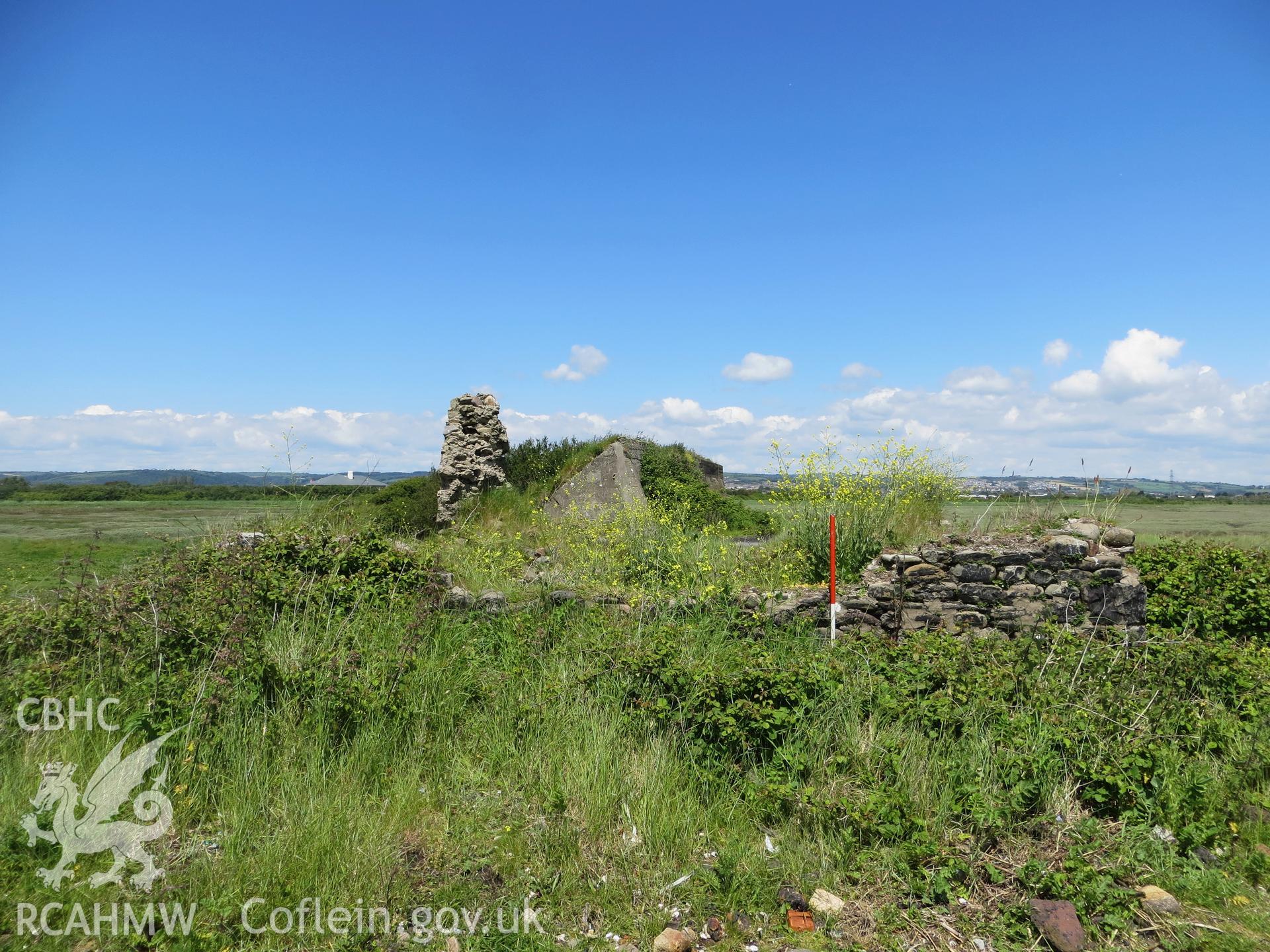 View from the south, target area NPRN 420182 behind; 1m scale.