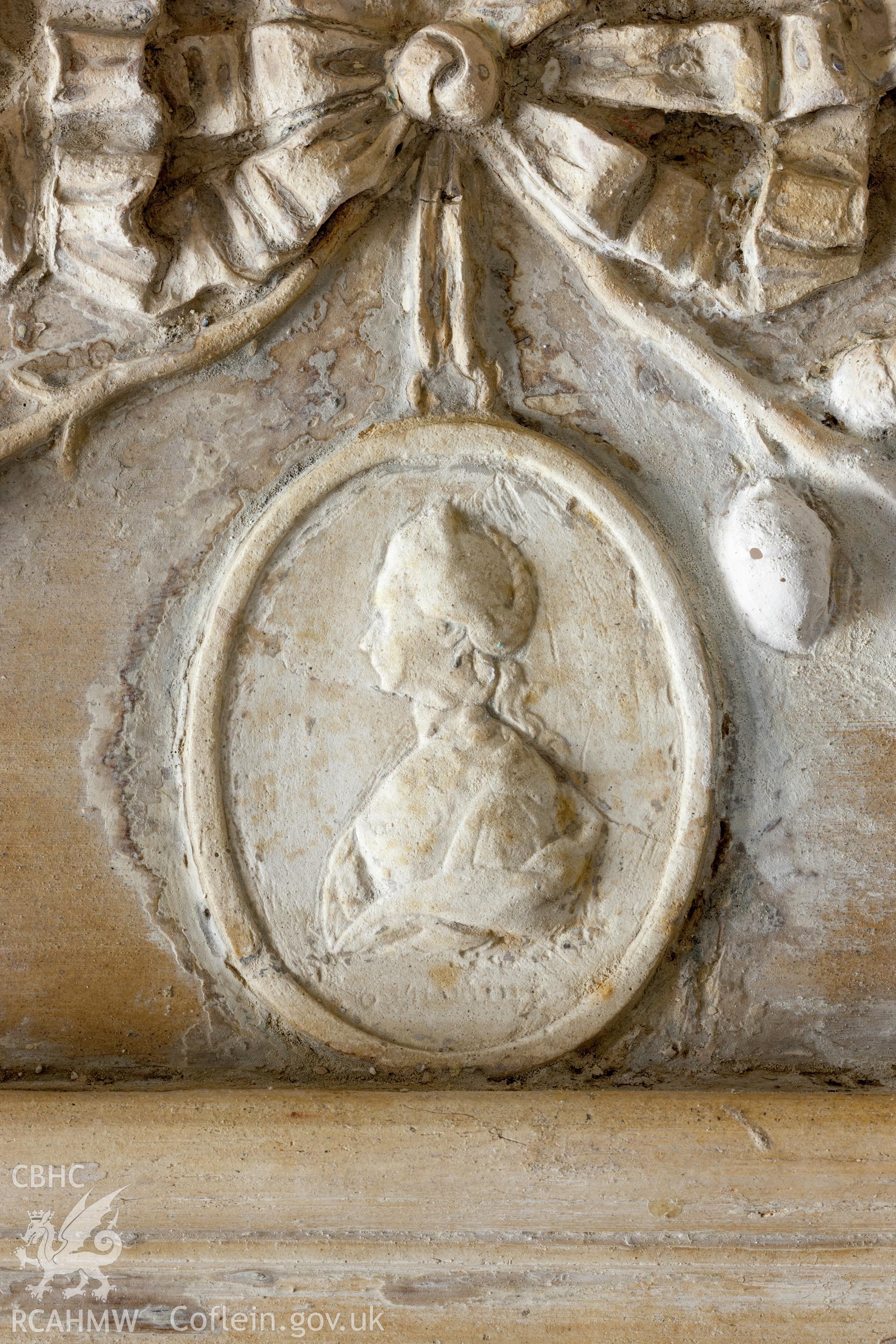 Interior of decorated plaster room, detail of plaster over fireplace