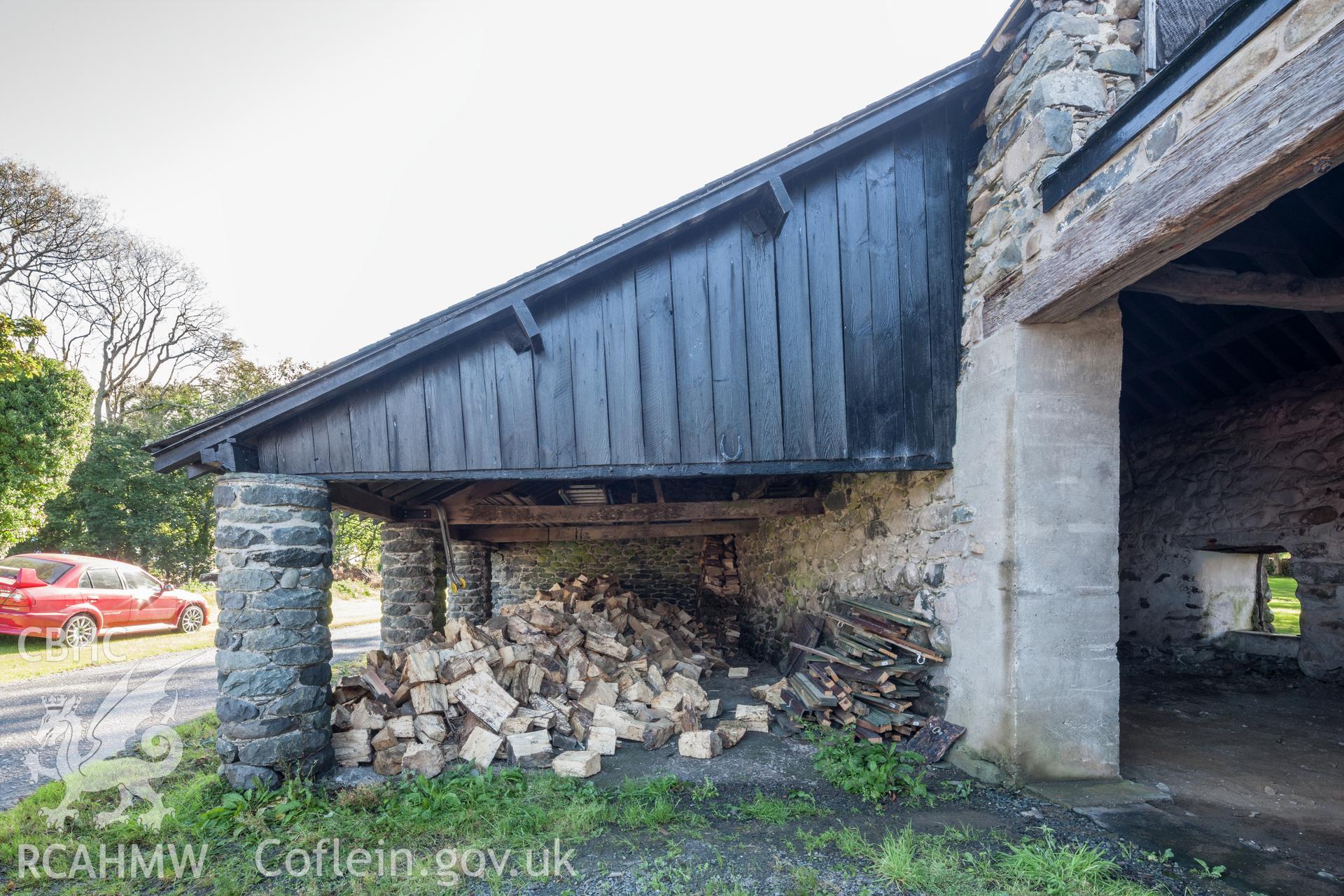 Exterior of barn, side extension on stone pillars viewed from the northwest