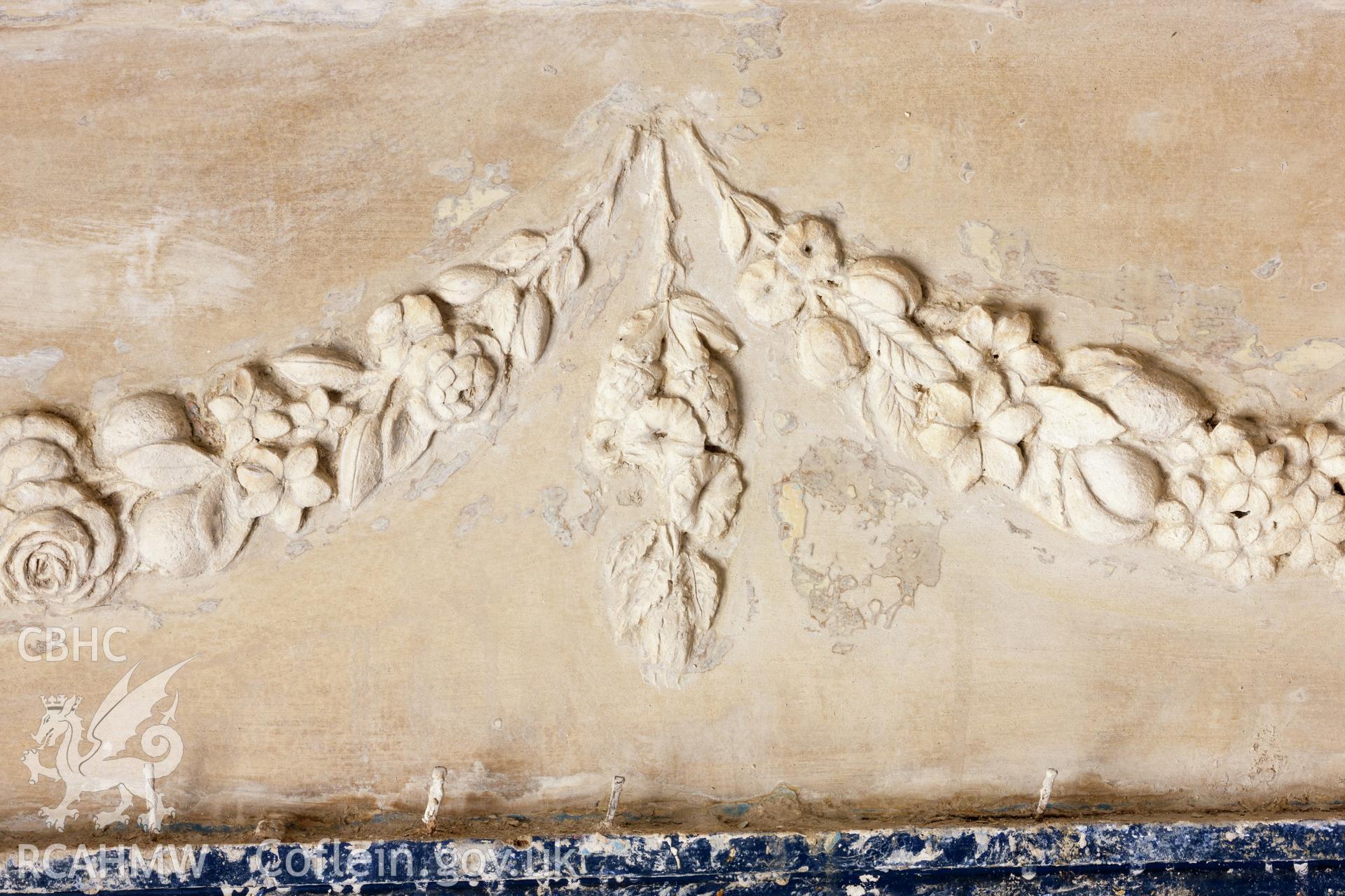 Interior of decorated plaster room, detail of plaster over doorhead (north)