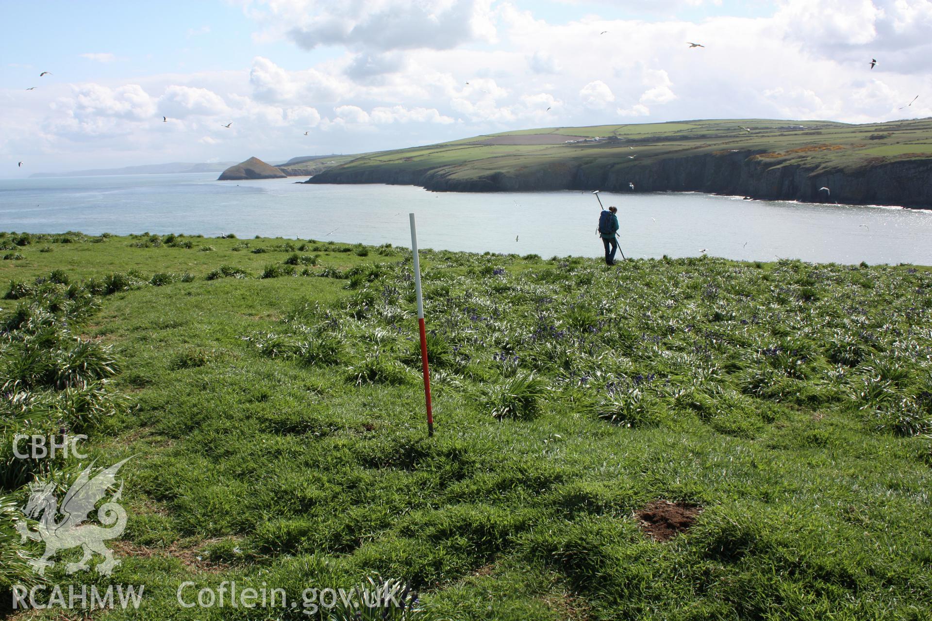 View looking south-east along the curving section of  bank that defines the north and east sides of the settlement enclosure.