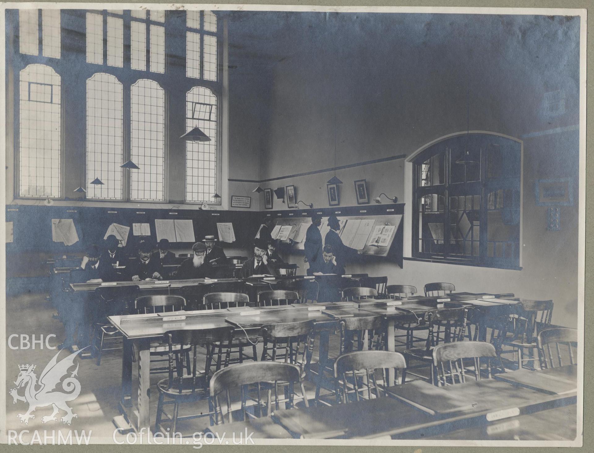 Black and white photograph showing people reading in Cathays Public Library, Cardiff.