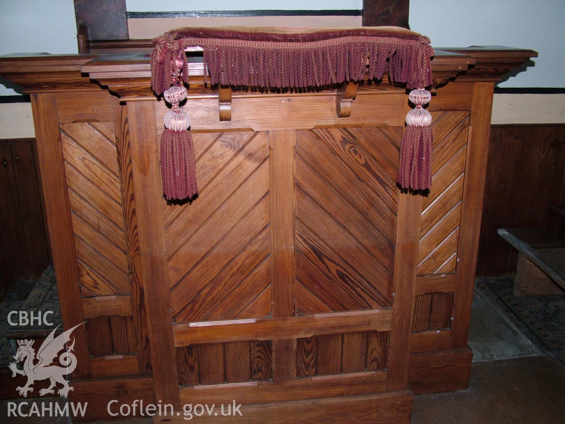 Digital colour photograph showing Llwynypandy chapel - interior view showing pulpit and velvet cushion