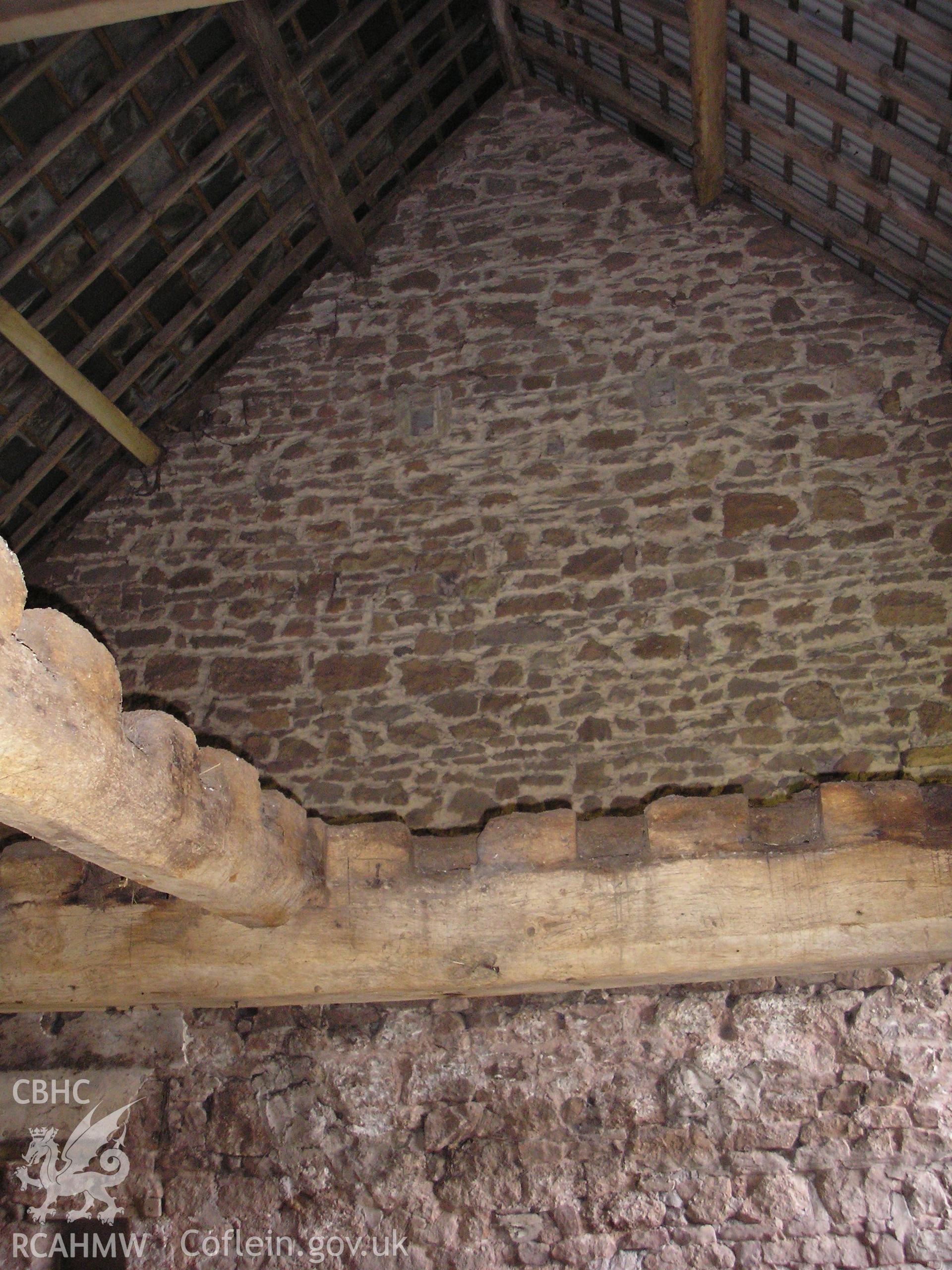 Interior of barn showing gable wall and roof timbers