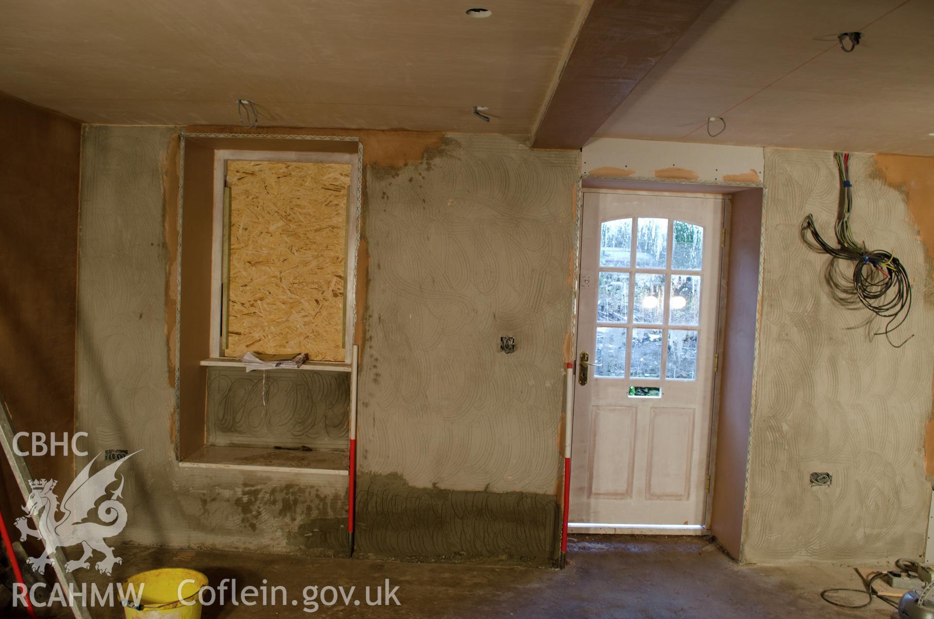 View from the west. "East elevation (front door and window) in what will be the dining room".