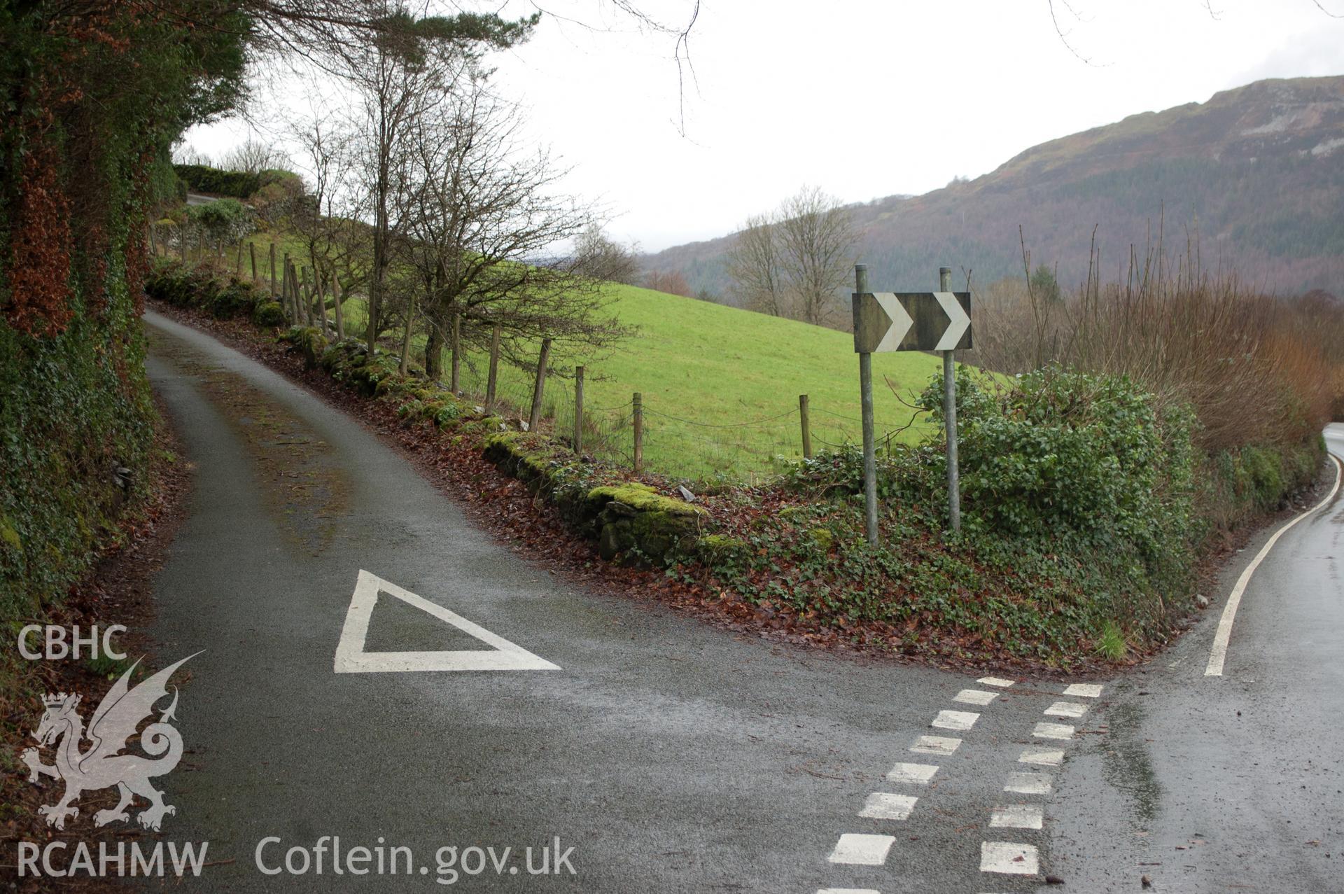 Marian Mawr archaeological assessment; section B-C, view from E showing point at which pipeline leaves road and crosses sloping field,  taken by Robert Evans of Gwynedd Archaeological Trust, 5th February 2016.