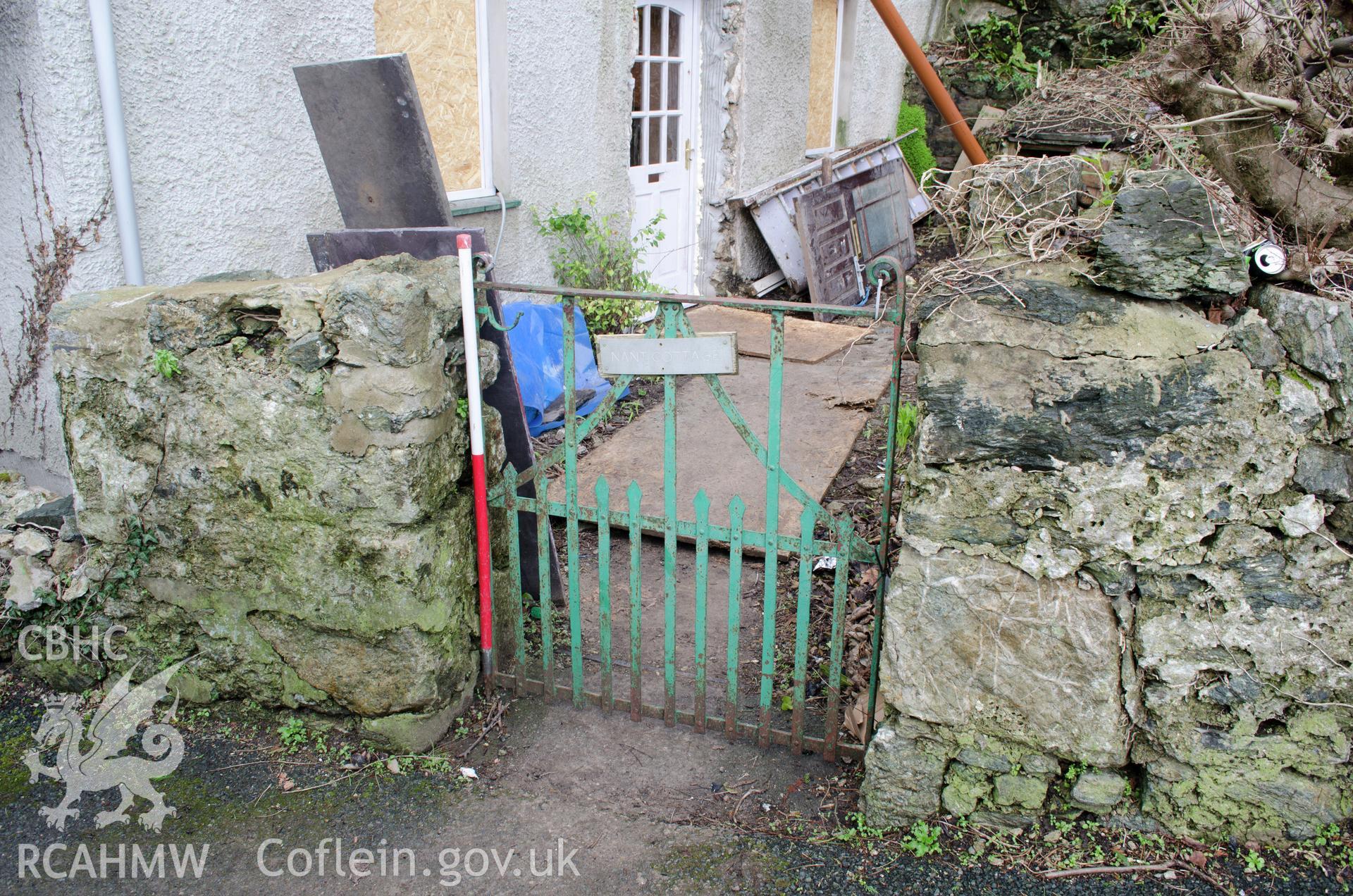 View from the south showing cast iron gate and wall for entrance into cottage garden.