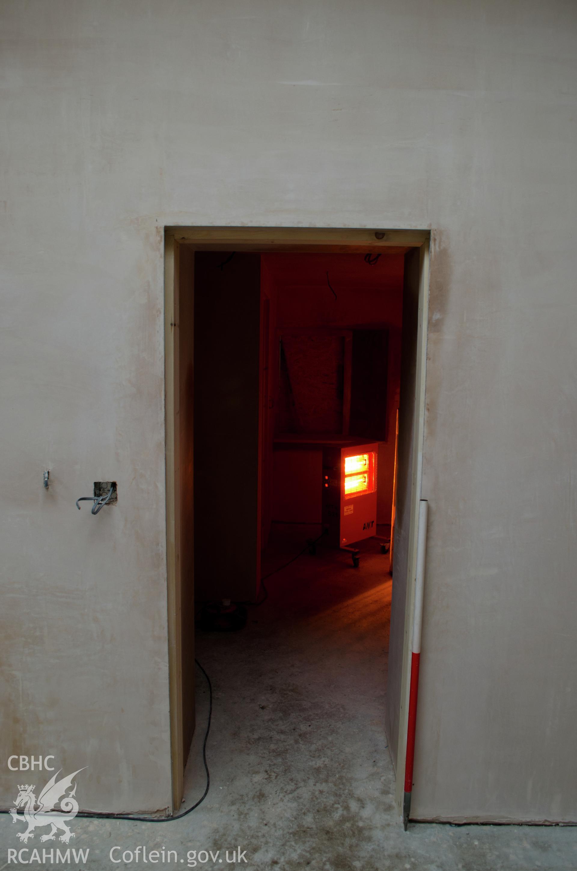 View from the north showing doorway between new extension and rear hallway, at western end of cottage.