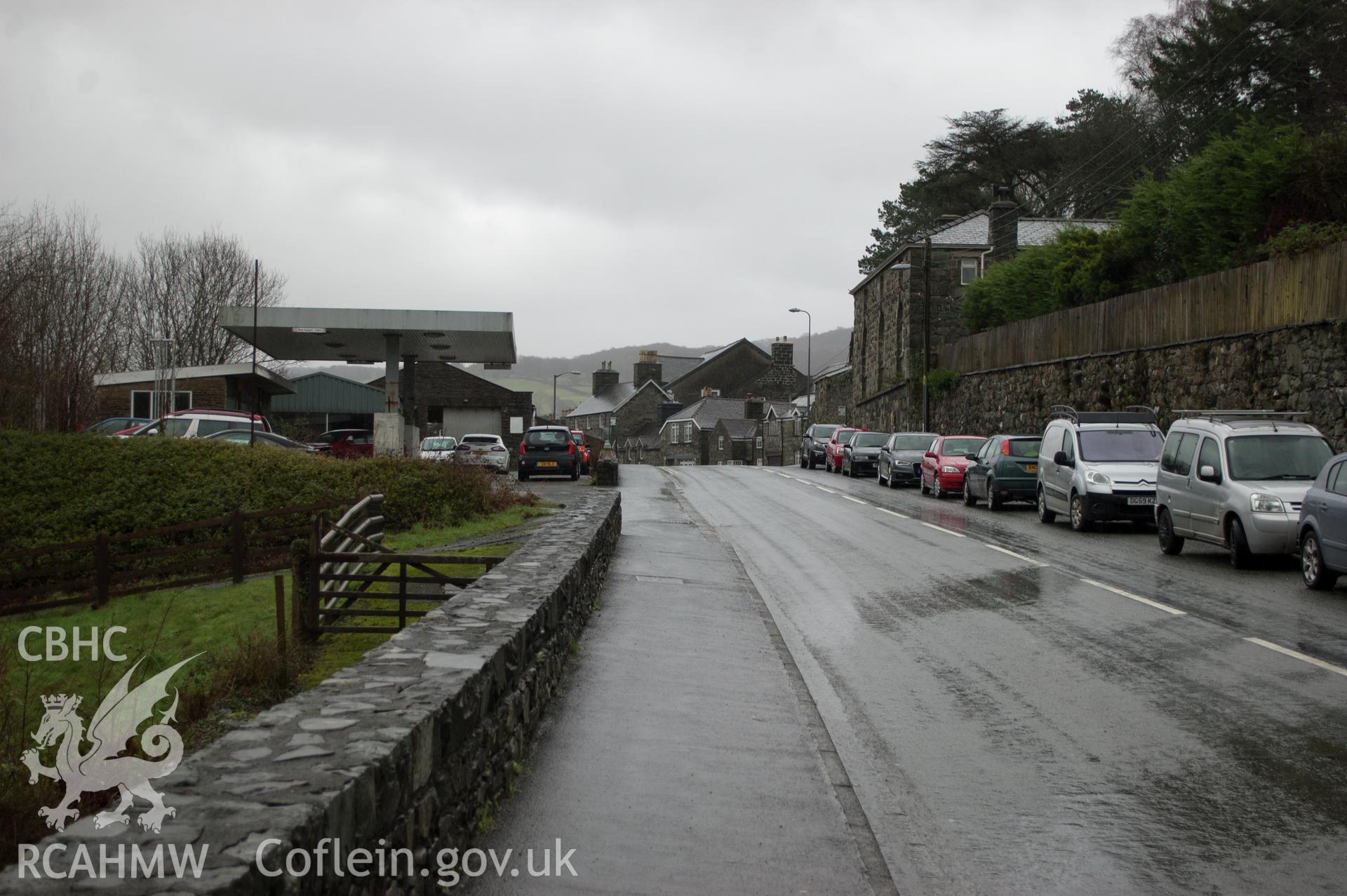 Marian Mawr archaeological assessment; section C-D, view from W showing view along street showing pipe route in pavement, taken by Robert Evans of Gwynedd Archaeological Trust, 5th February 2016.