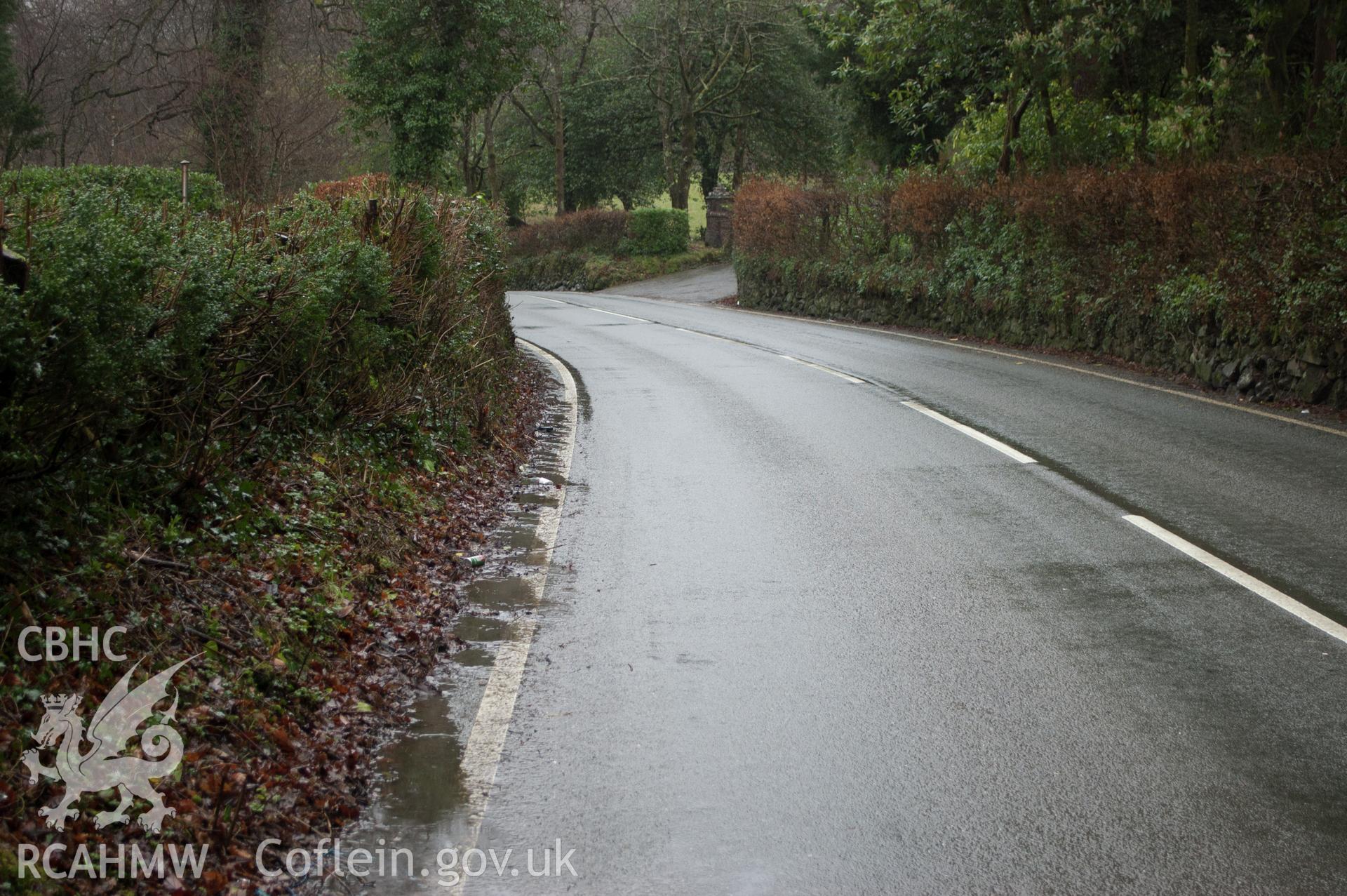 Marian Mawr archaeological assessment; section B-C, view from W showing view along street showing pipeline route in pavement, taken by Robert Evans of Gwynedd Archaeological Trust, 5th February 2016.
