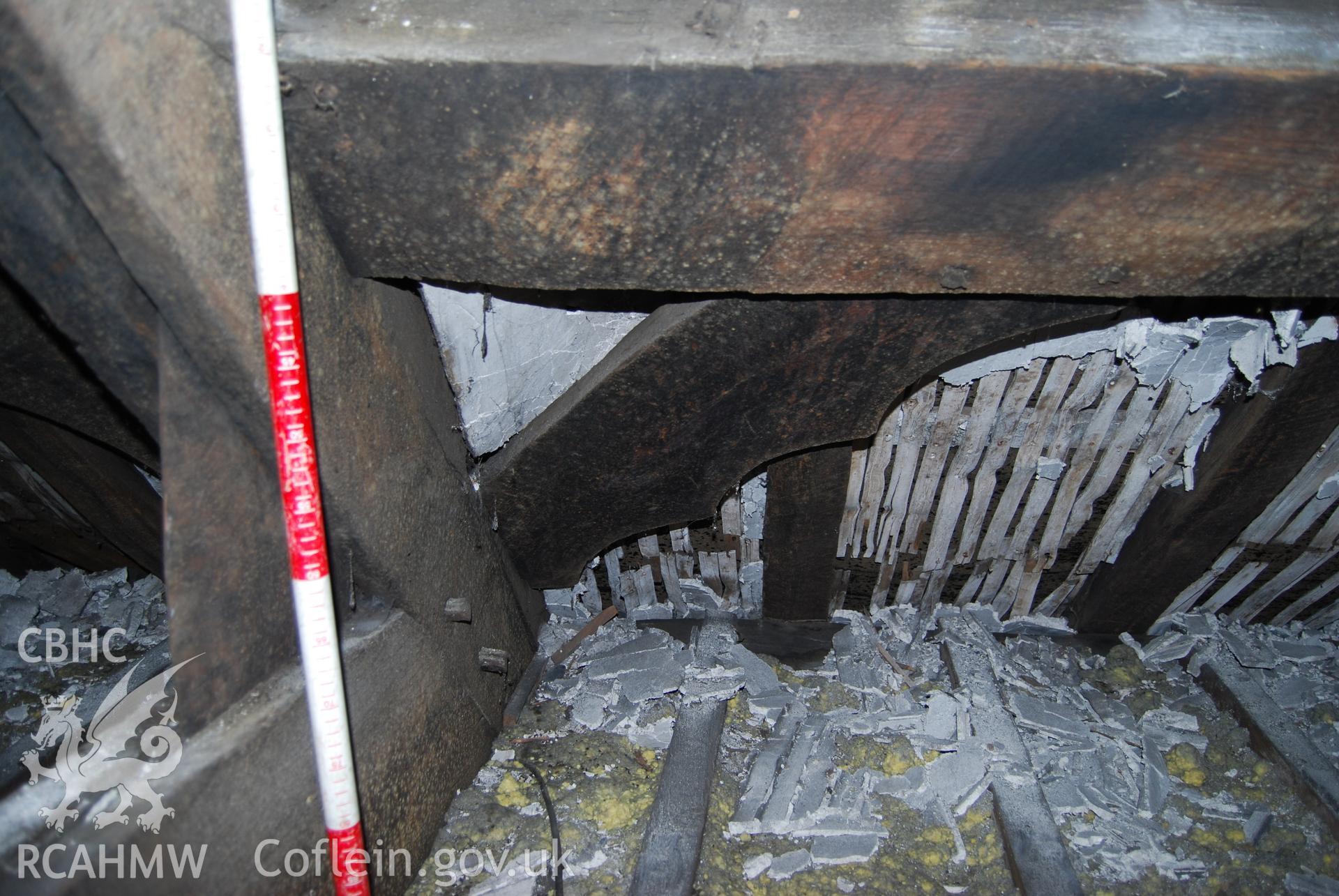 Colour digital photograph showing purlins and a wind brace attached to the East side of roof truss number four, showing oak planking. The photograph was taken at Ty Eiddew, Harlech, as part of the North West Wales Dendrochronology Project.