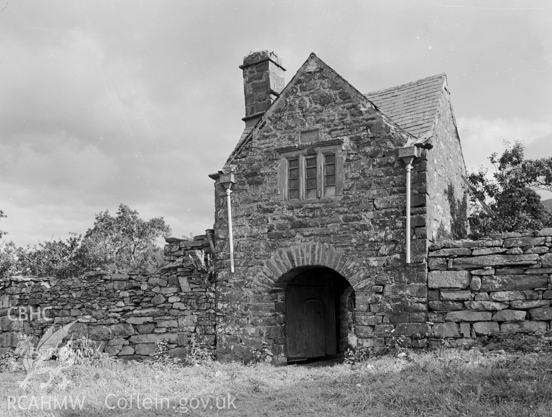 A two storey high, stone gatehouse.