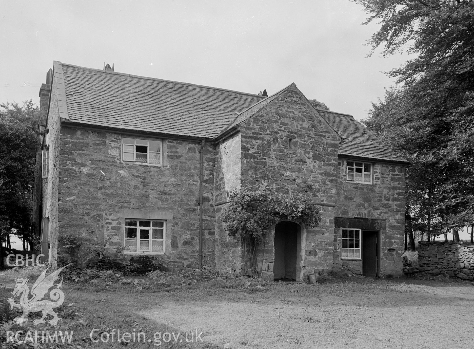 A 2 storey stone building with a slate pitched roof. Has a two storey stone porch.