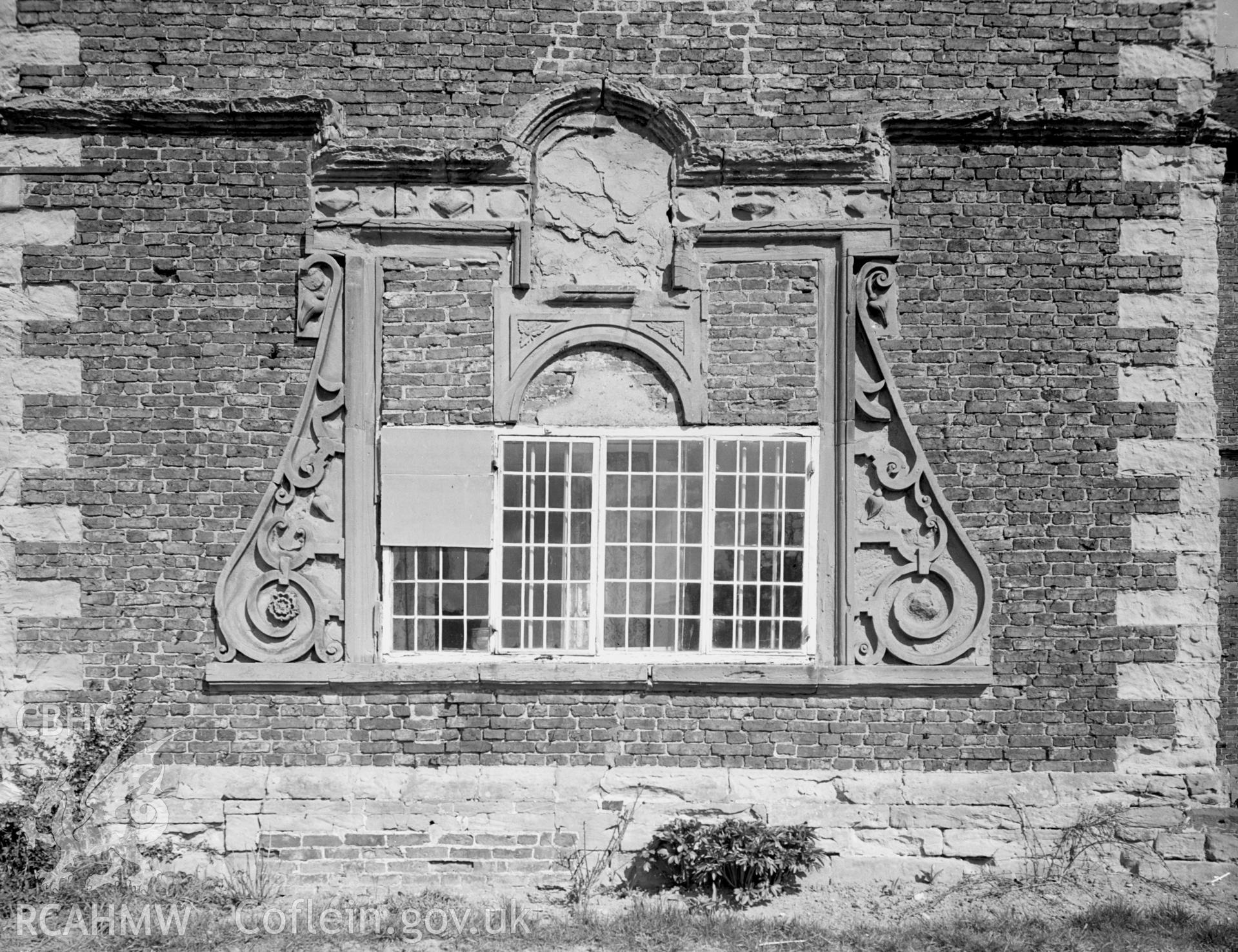 A view of the ground floor, gable projected, scroll-ornamented window (south wing).