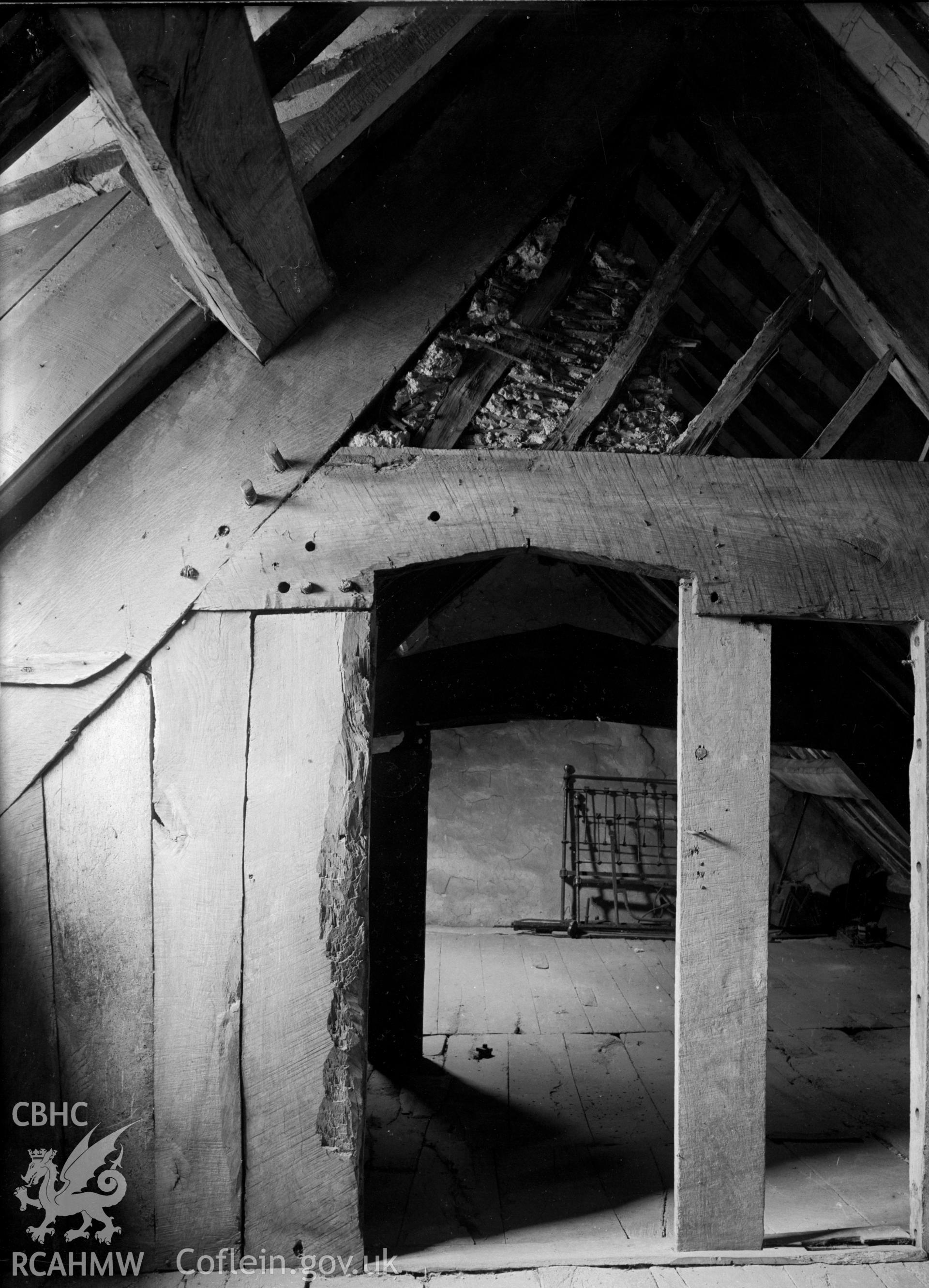 A view of wooden roof partitioning showing wattle and daub.