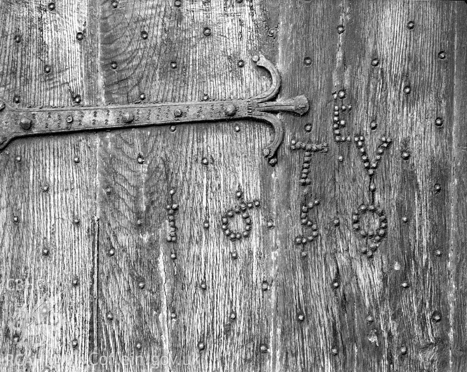 A massive oak door, dated in studs 1659.