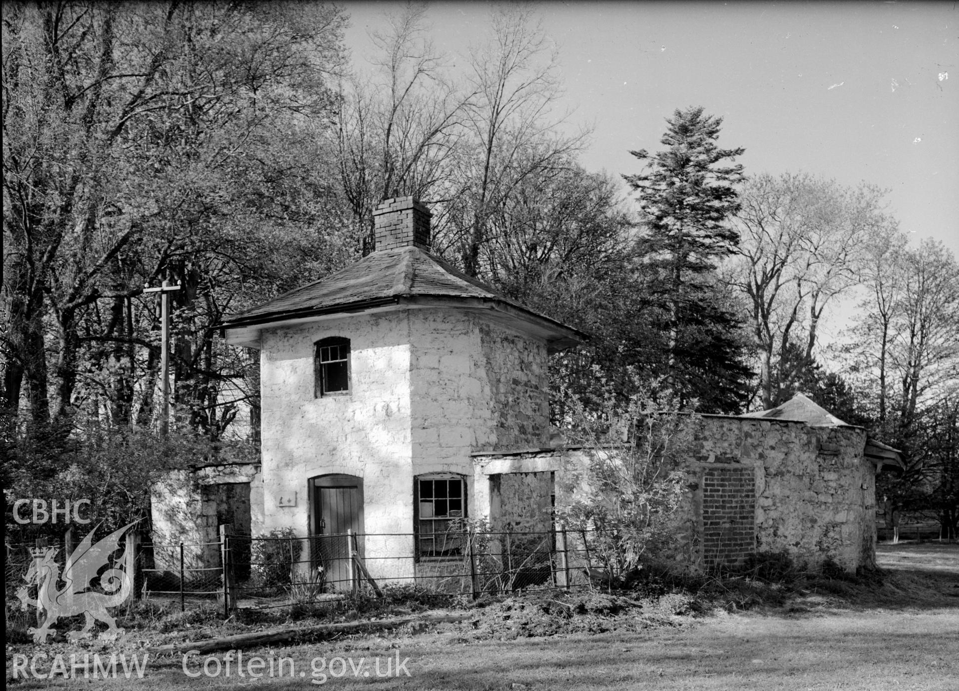 A small two storey tower with a single chimney in the apex of the roof.