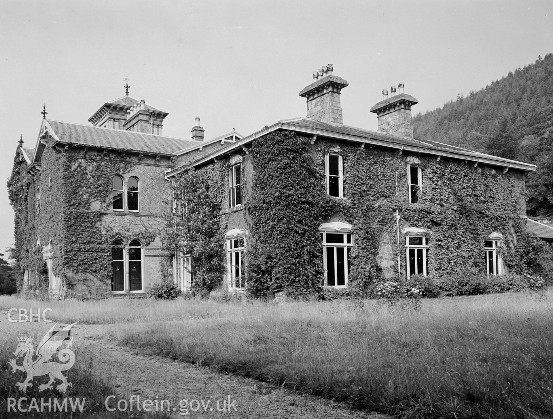 Coed-y-Celyn form the south west showing a hipped roof and two chimney stacks.