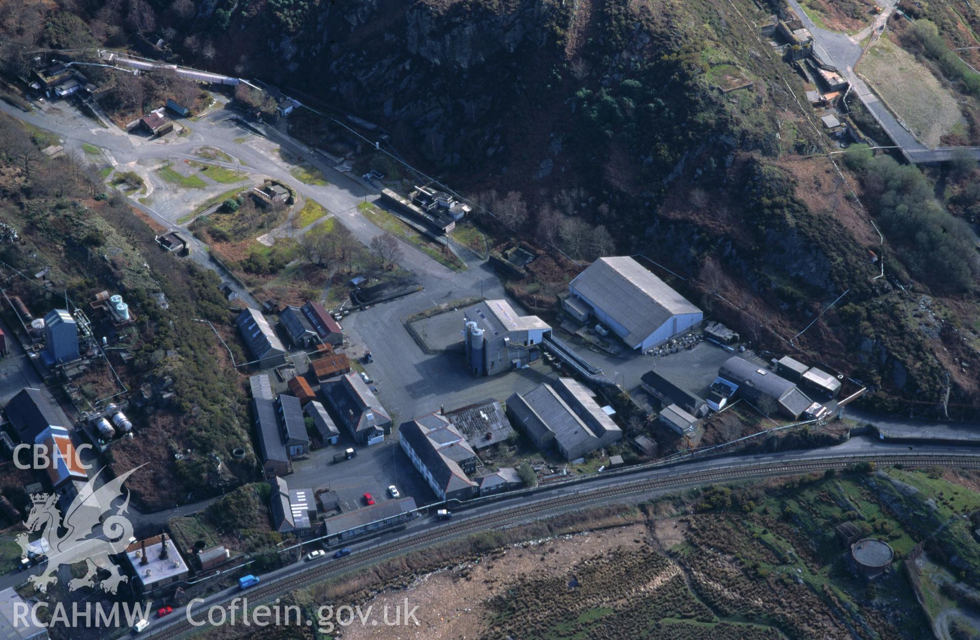 RCAHMW colour oblique aerial photograph of Cooke's Explosive Works, Penrhyndeudraeth taken on 12/04/1995 by C.R. Musson