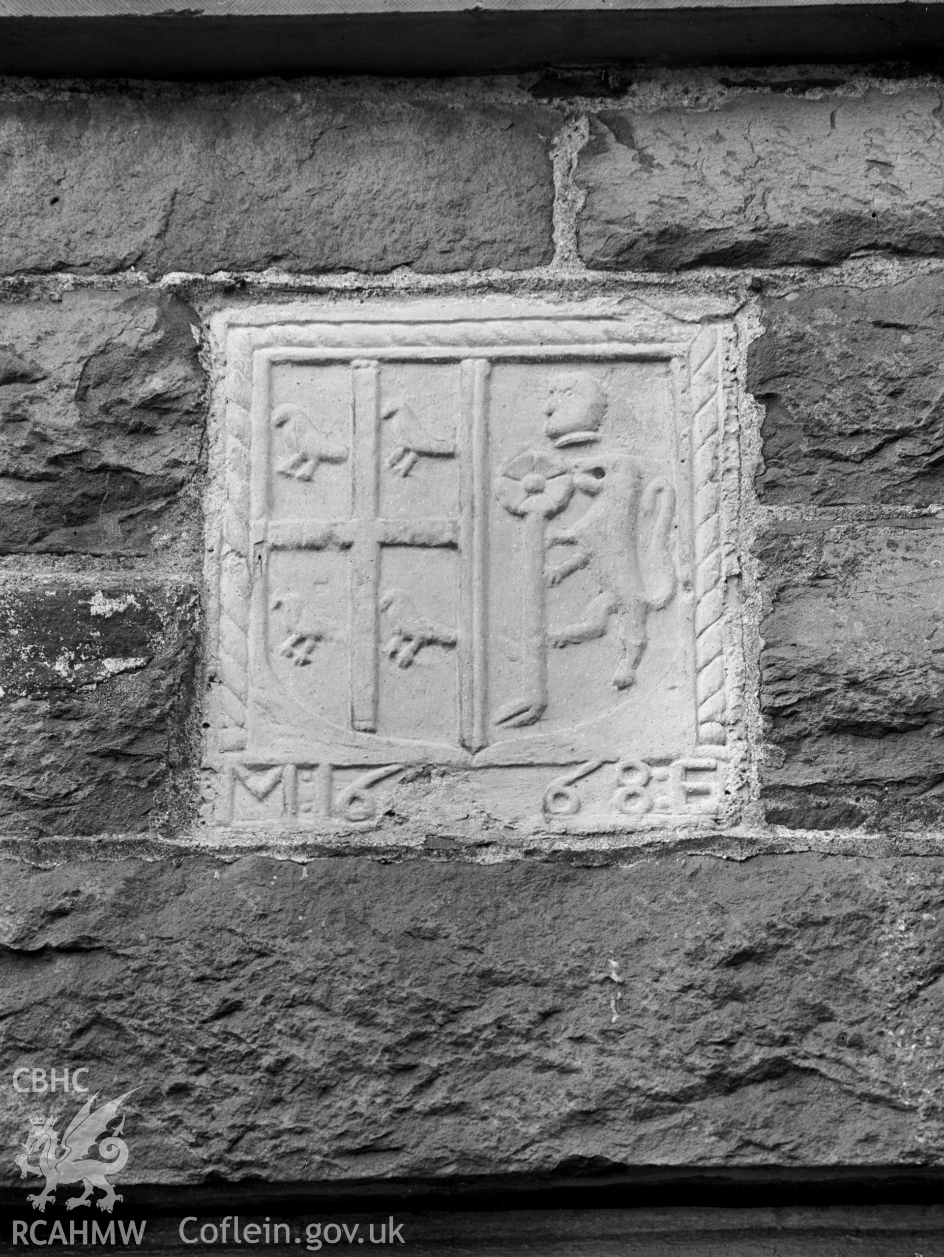 A panel from an earlier house showing a coat of arms and the date 1668.
