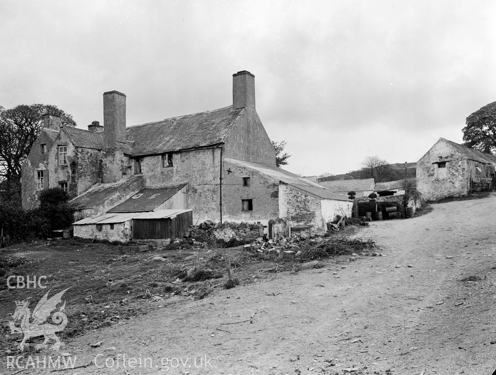 A view of a stone built farmhouse. Has a number of lean-to's attached.