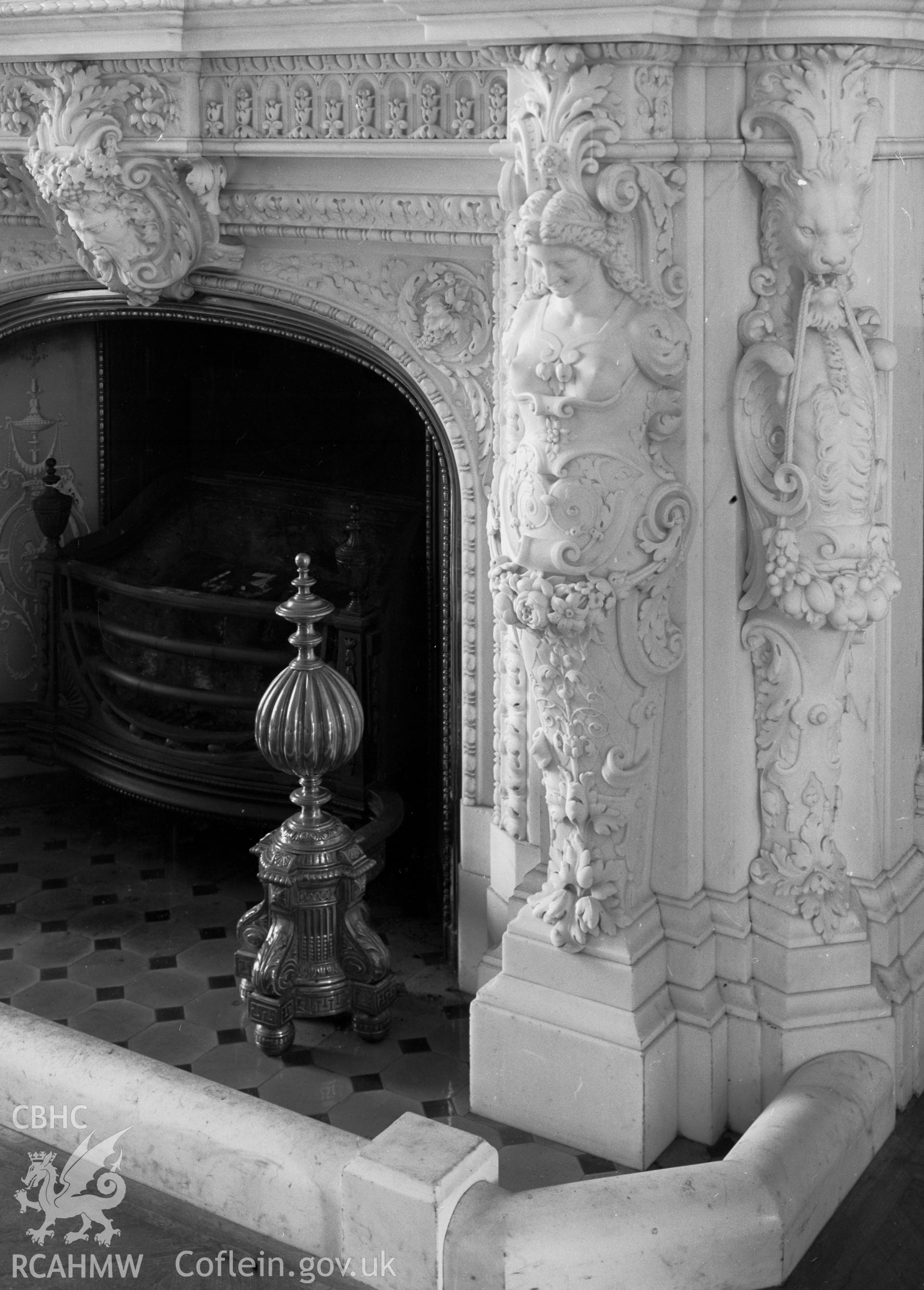 A large carved marble fireplace, in the drawing room.