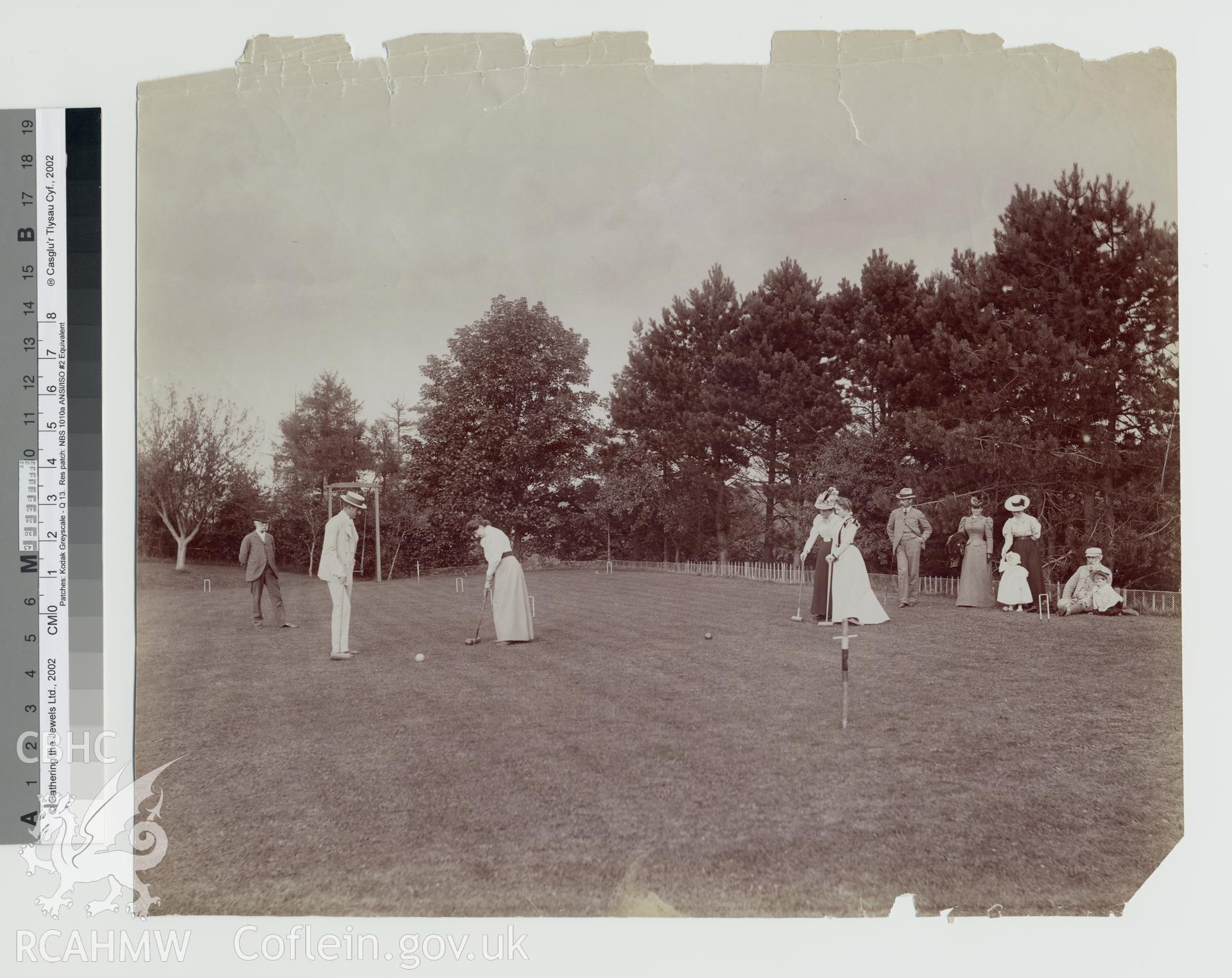Black and white photograph taken at the time of construction of the Elan Valley Water Scheme, showing ladies and gentlemen playing croquet. Copy negative held.