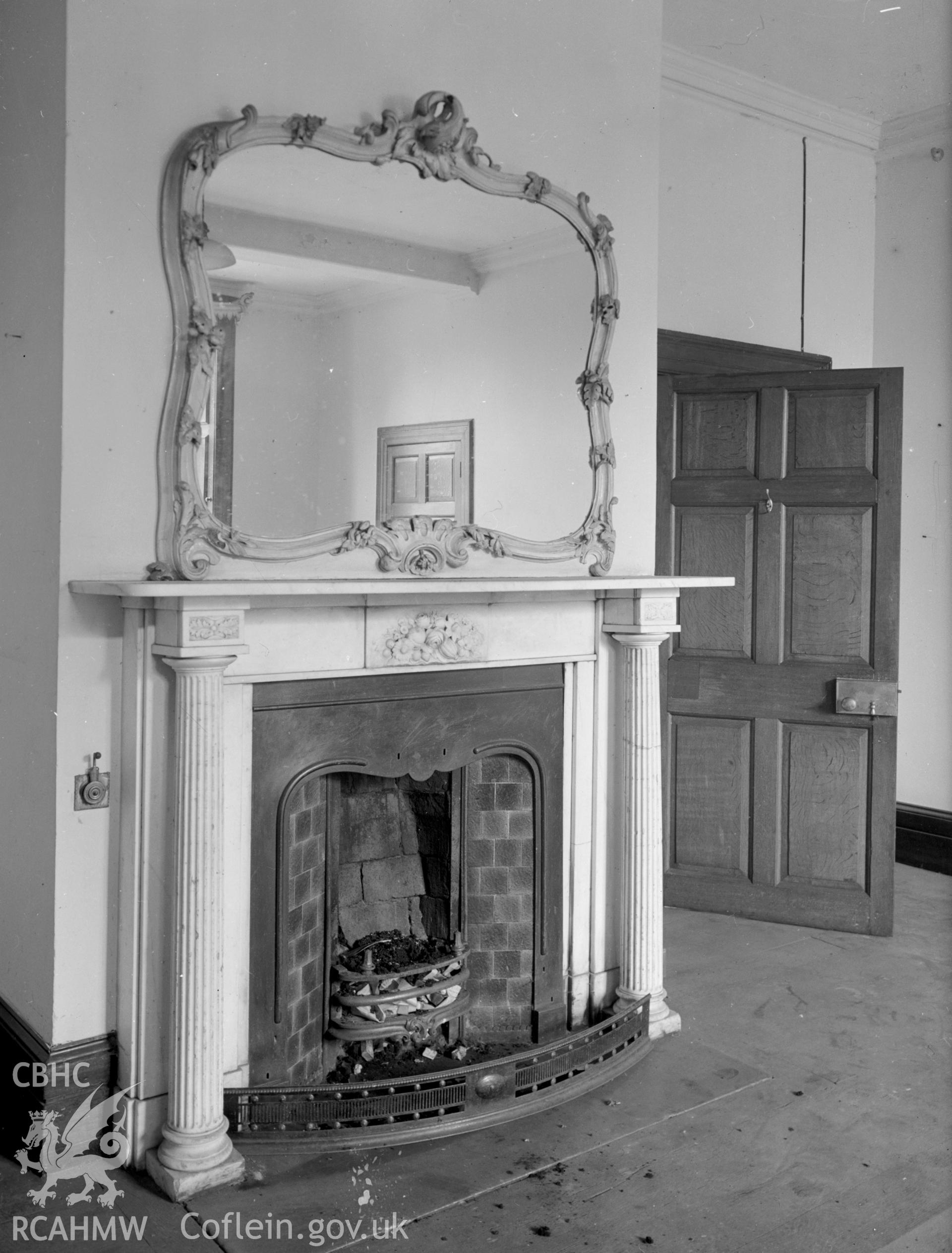 A bedroom fireplace with engaged Greek Doric columns as part of the surround, supporting the mantle.