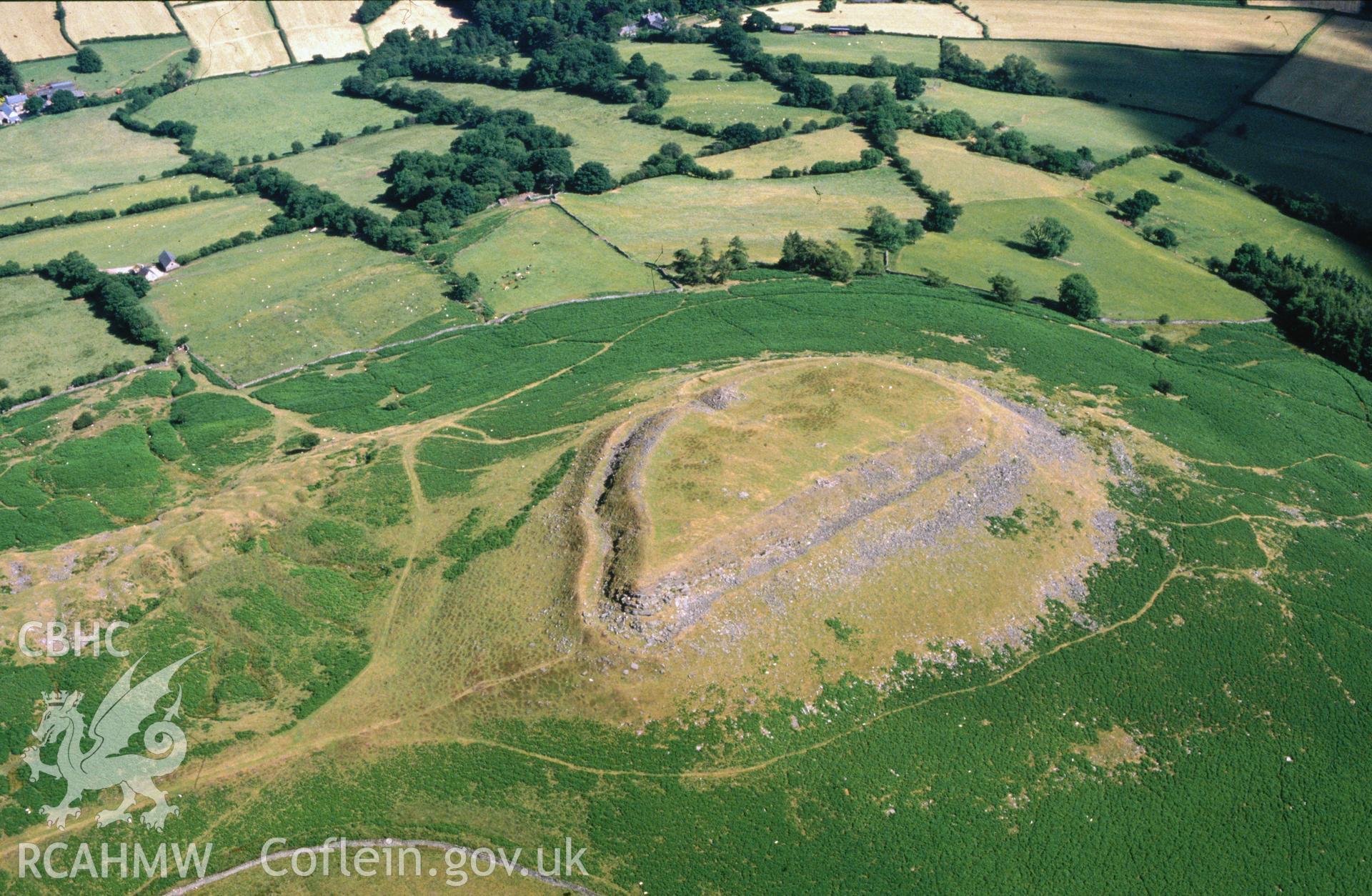 Slide of RCAHMW colour oblique aerial photograph of Crug Hywel Camp, taken by C.R. Musson, 29/6/1989.