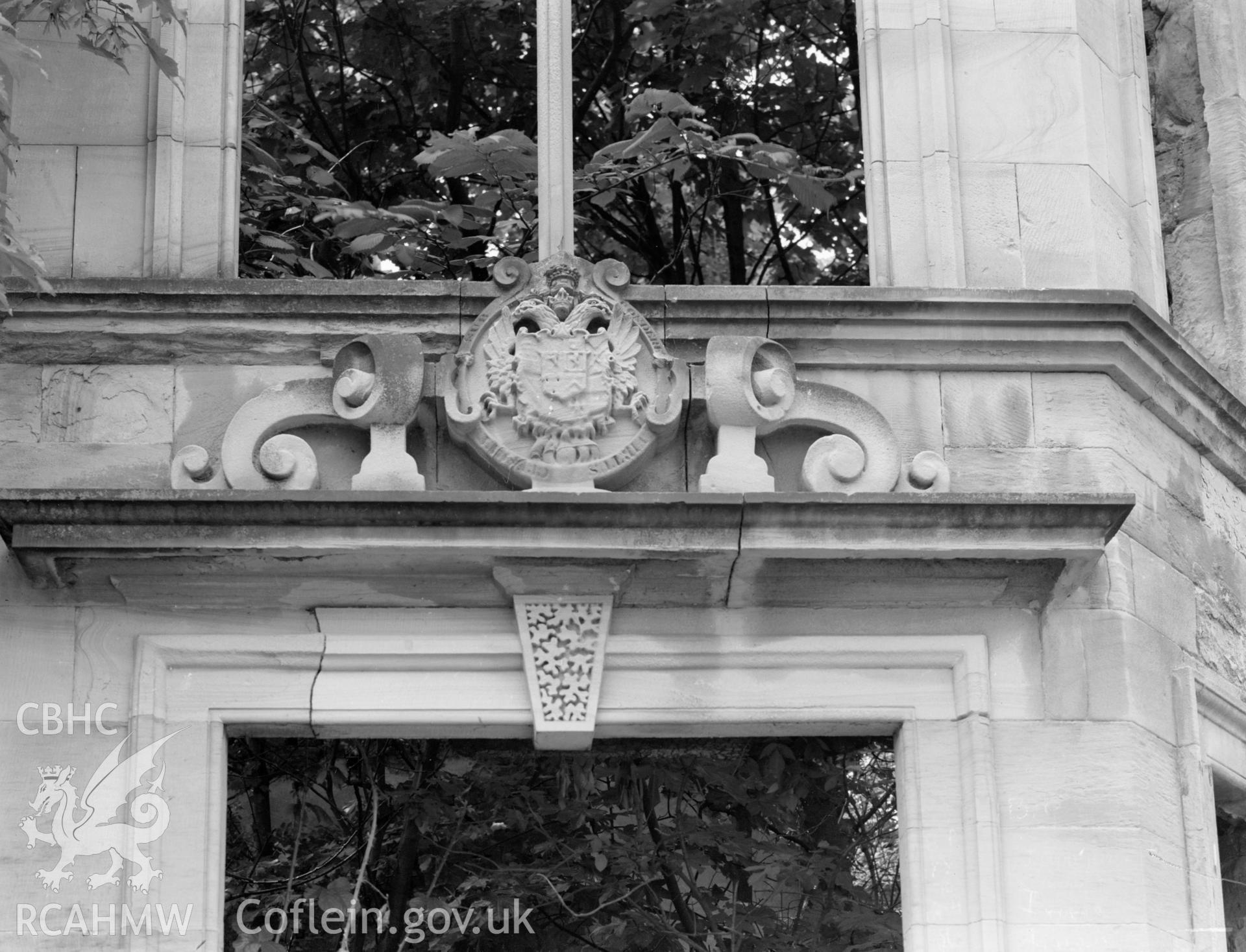 A coat of arms panel above the south east door.