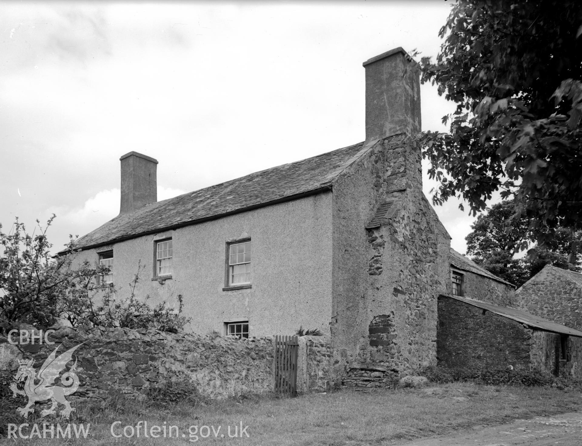 A view of a late 16th century two storey house, with a pitched slate roof and gable ended chimneys.