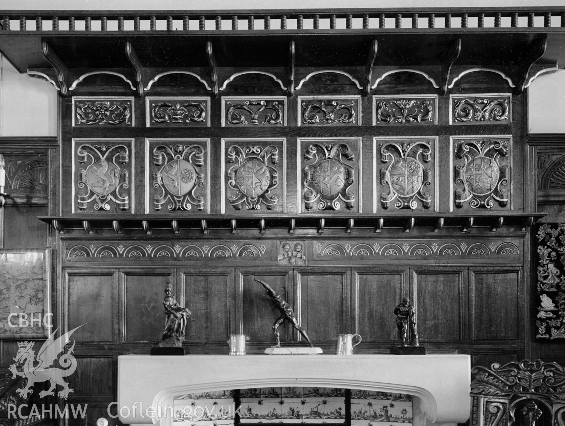 A carved fireplace situated in the Hall, showing a number of small "coat of arms".