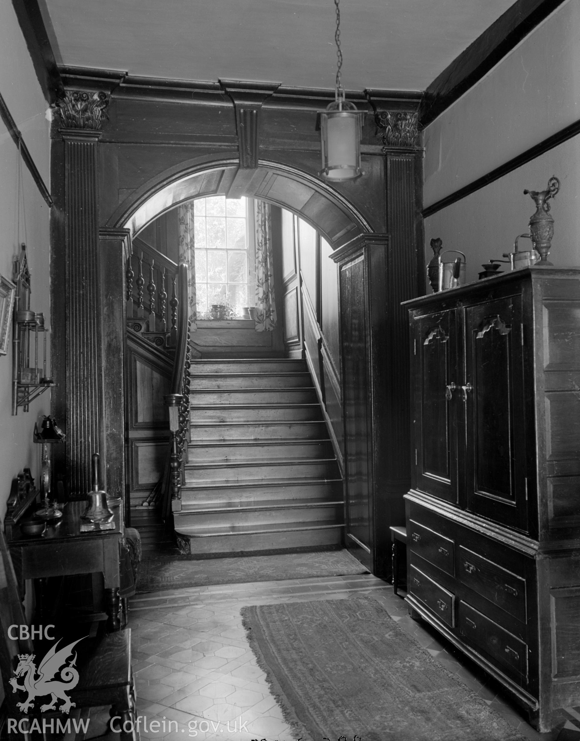 A view of a traditional hallway, showing wooden arch way .