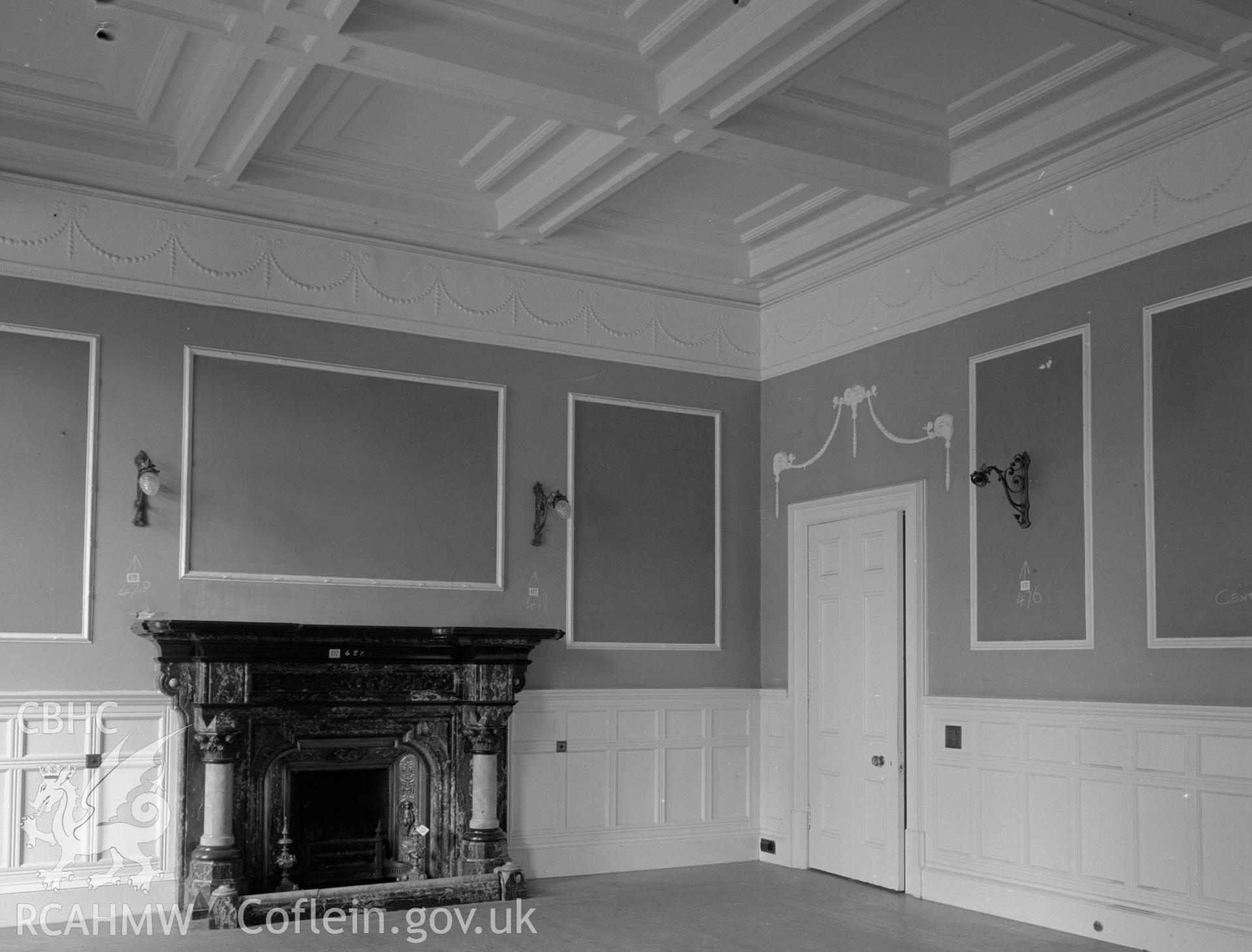 Dining room with the lower halves of the wall covered in wood panelling and a moulded ceiling.