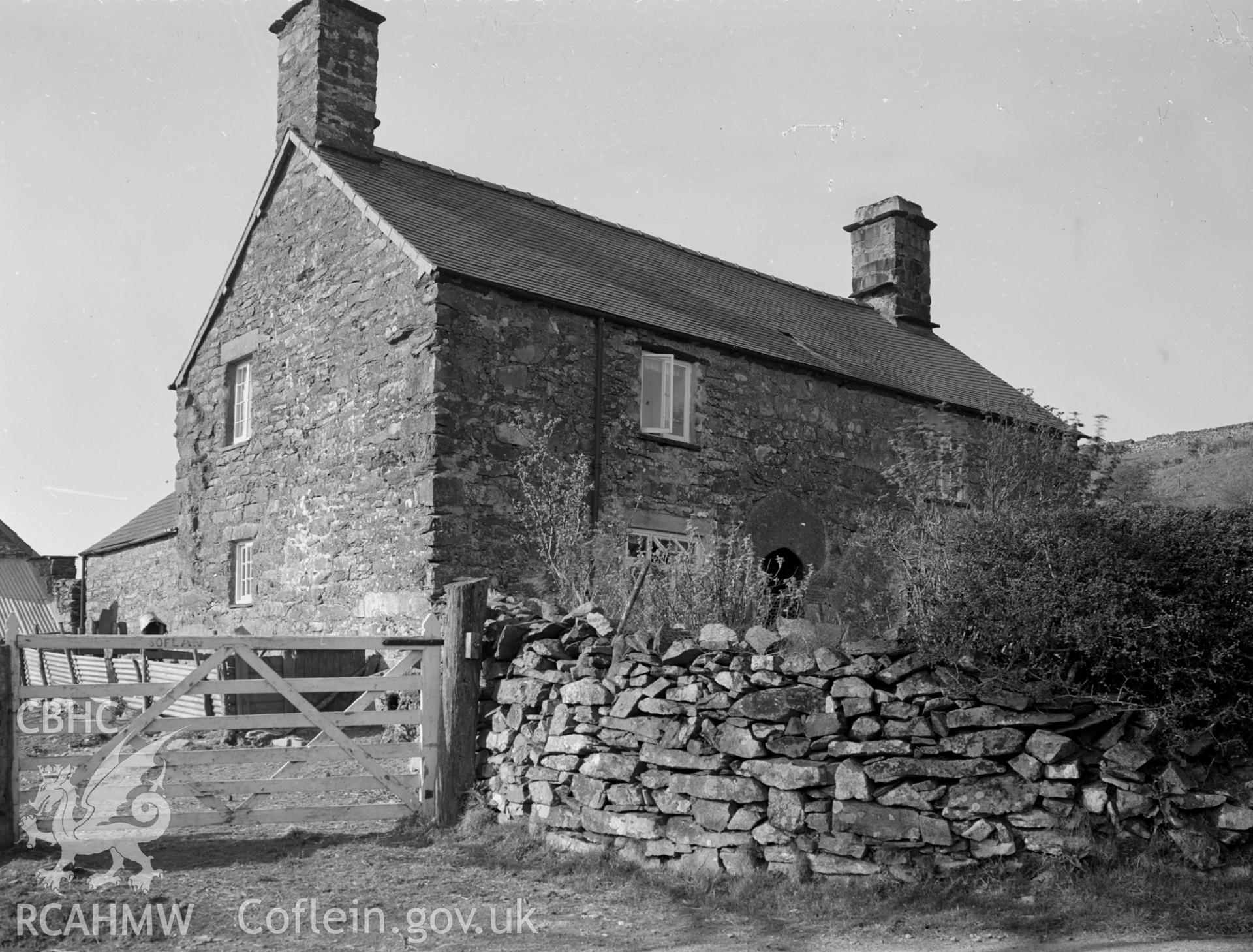 A 17th century stone rectangular house with two gable chimneys and a pitched roof.