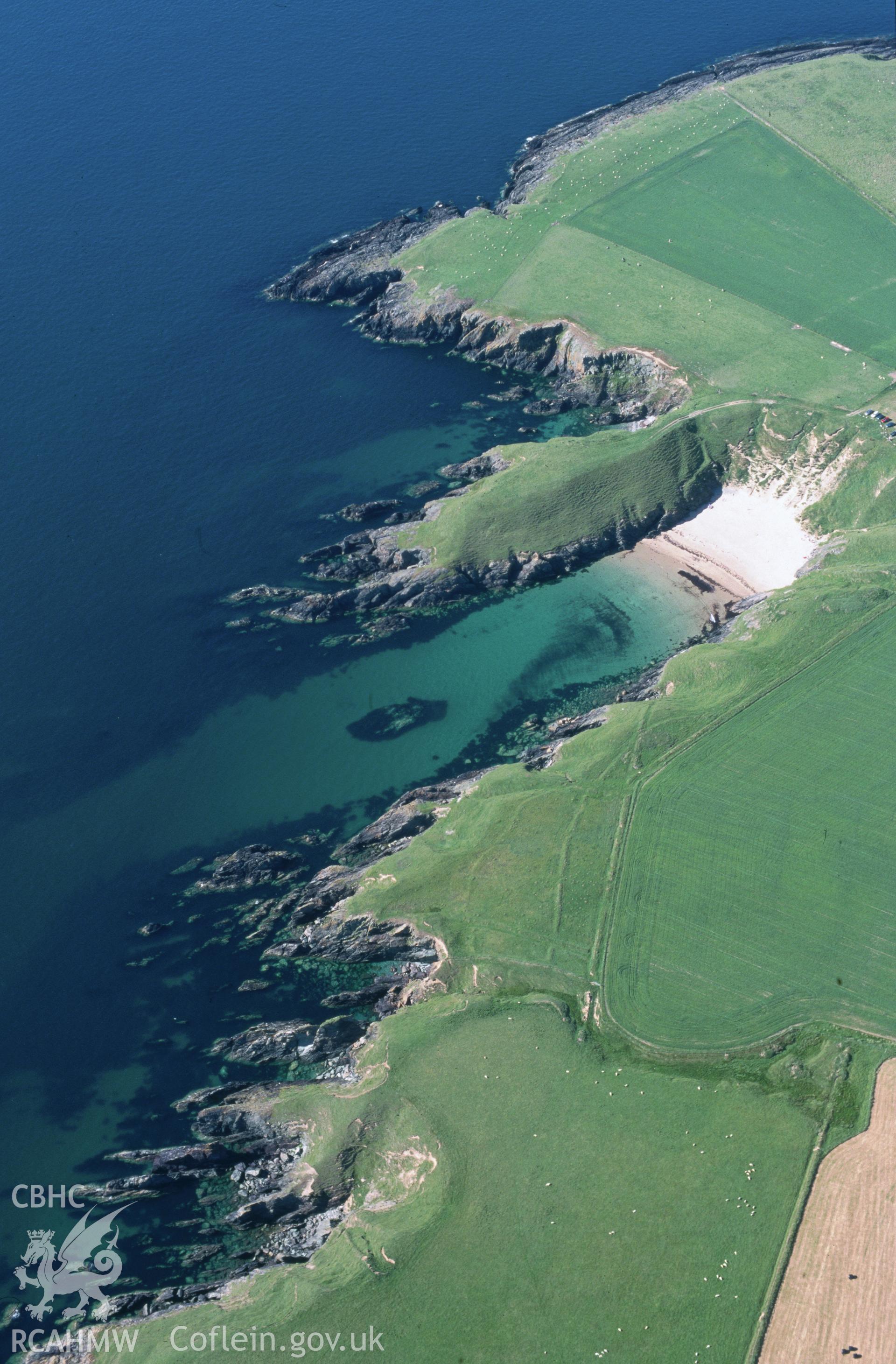 Slide of RCAHMW colour oblique aerial photograph of Dinas - Promontory Fort, Porth Iago, taken by T.G. Driver, 26/6/2000.
