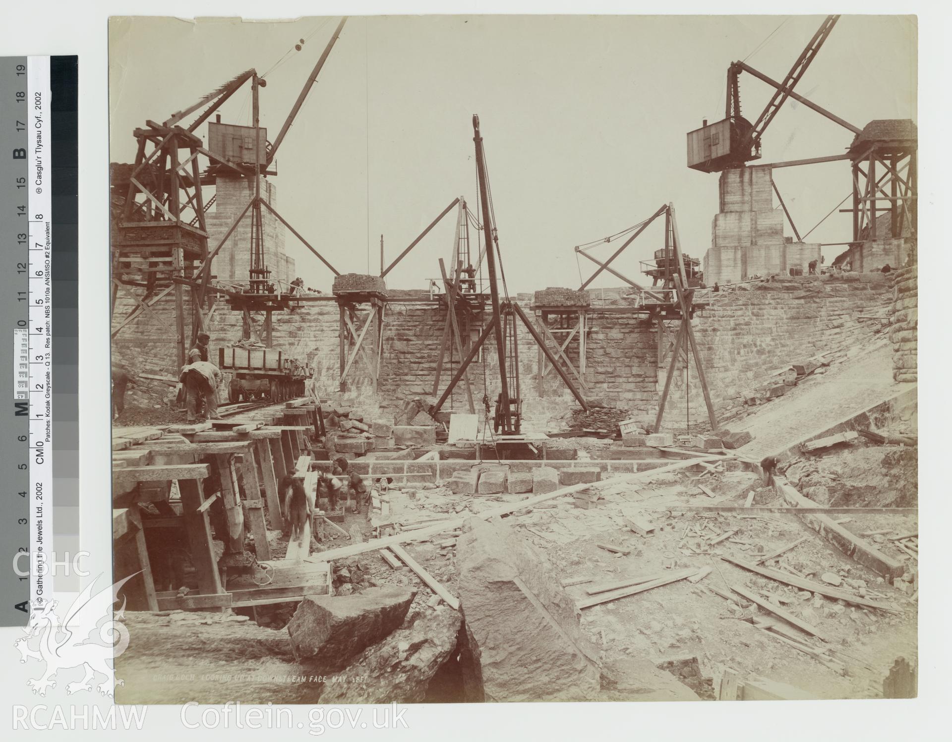 Black and white photograph of Craig Coch looking at downstream face. Copy negative held.