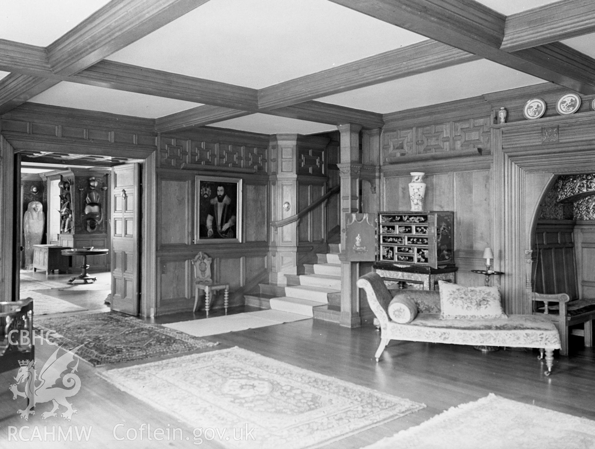 The west entrance of the Hall. With a moulded beam ceiling, wood panelled walls and a wooden floor.