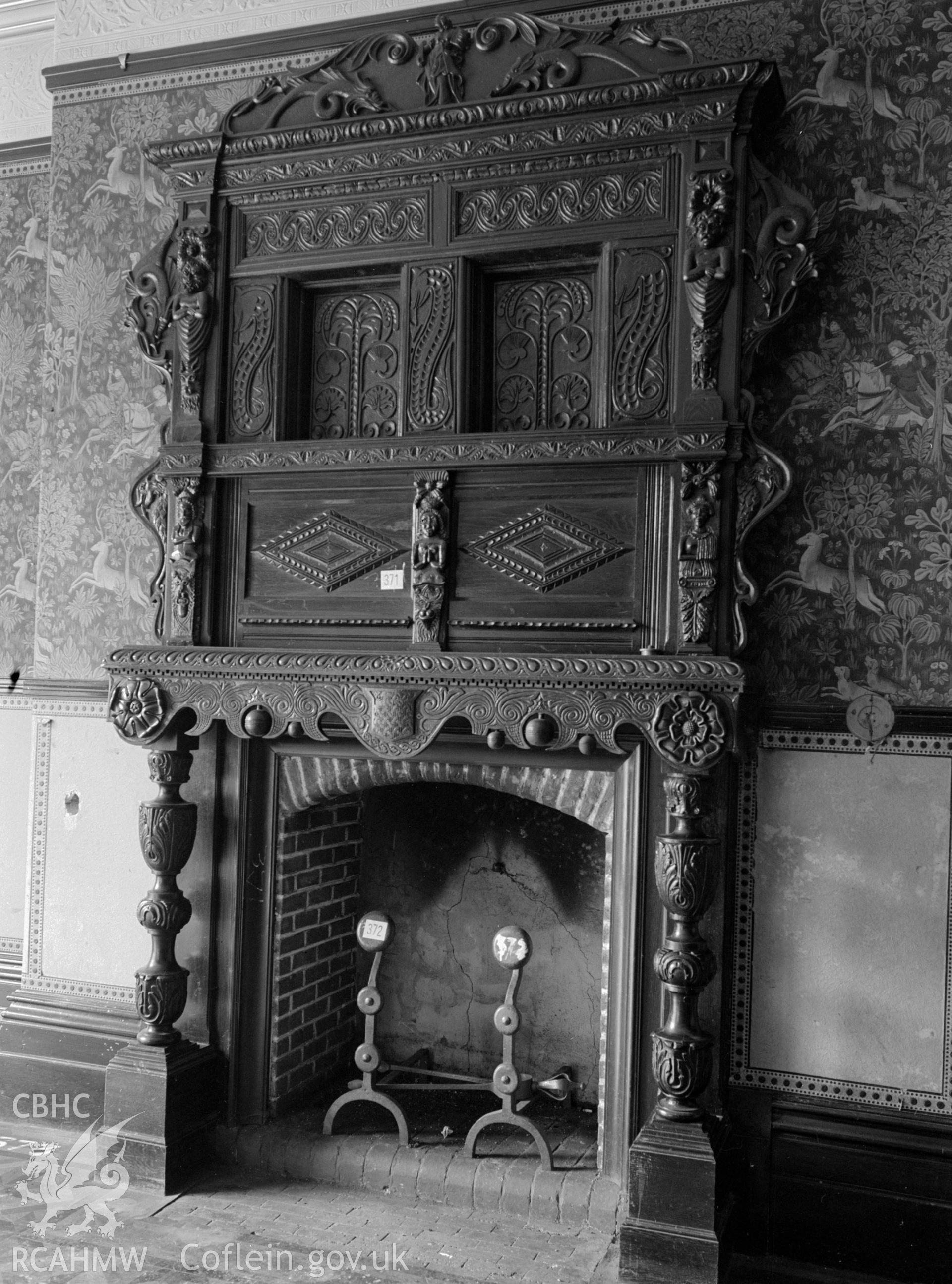 A view of a carved fireplace in the billiard room at coed-y-celyn.