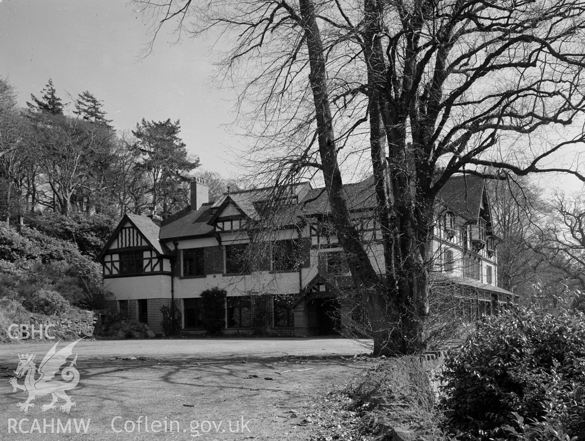 A large country mansion built in a Tudor style, set in a large country garden.